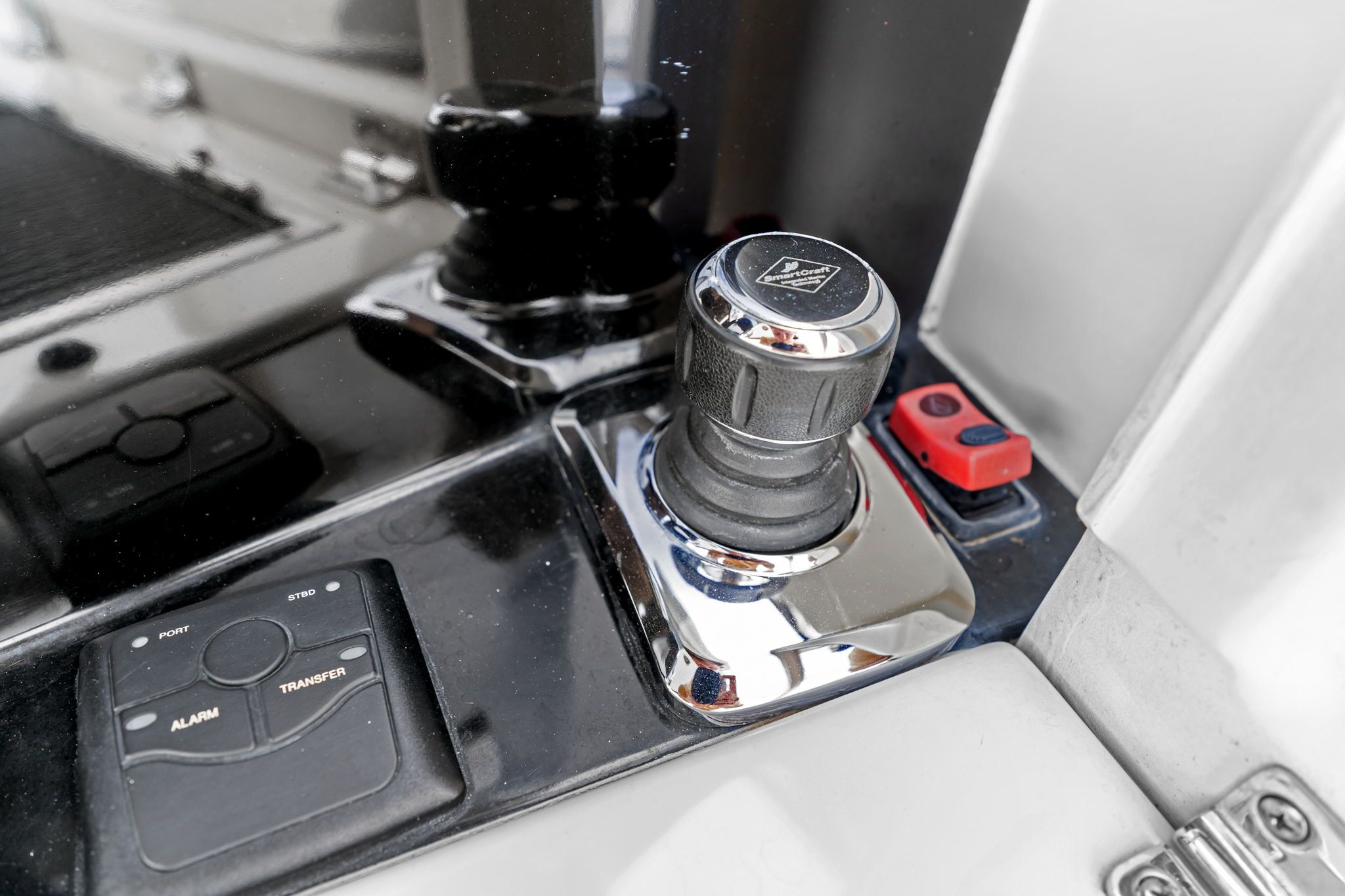 Close-up of a joystick and control panel on a yacht.