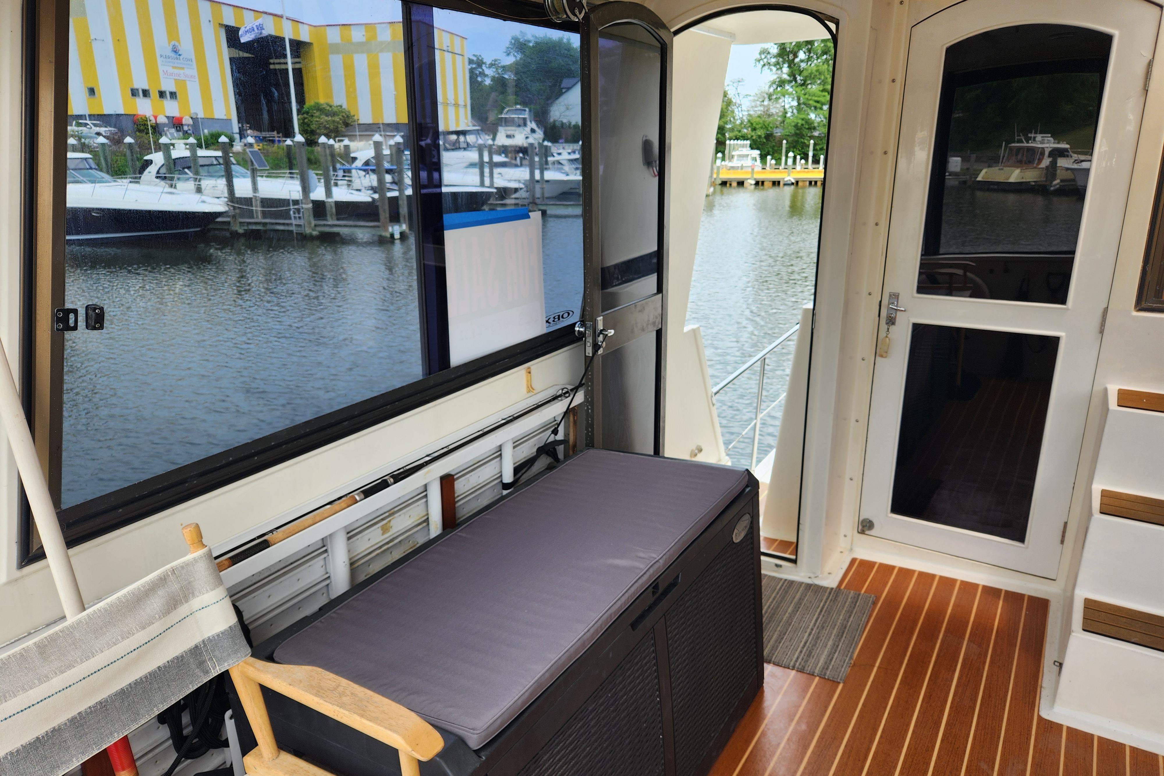 Interior view of 1989 Hyatt Double Cabin Motoryacht with marina backdrop.