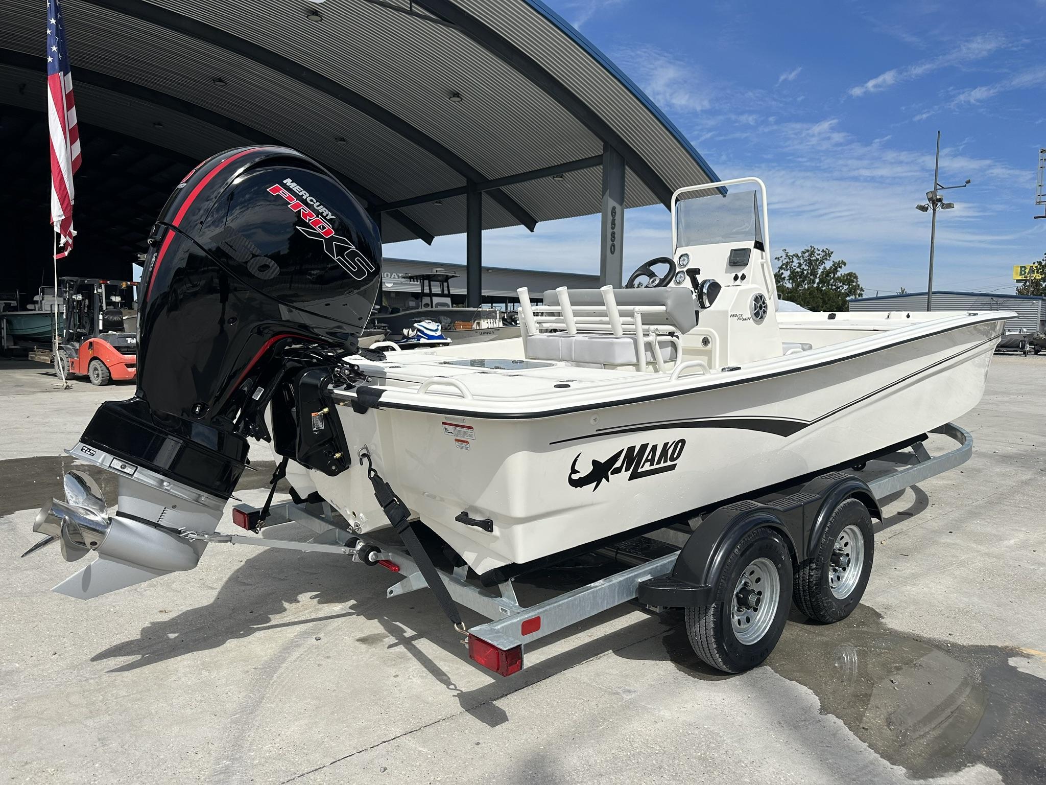 2024 Mako Pro Skiff 19 CC boat with Mercury engine on trailer, outdoor setting.