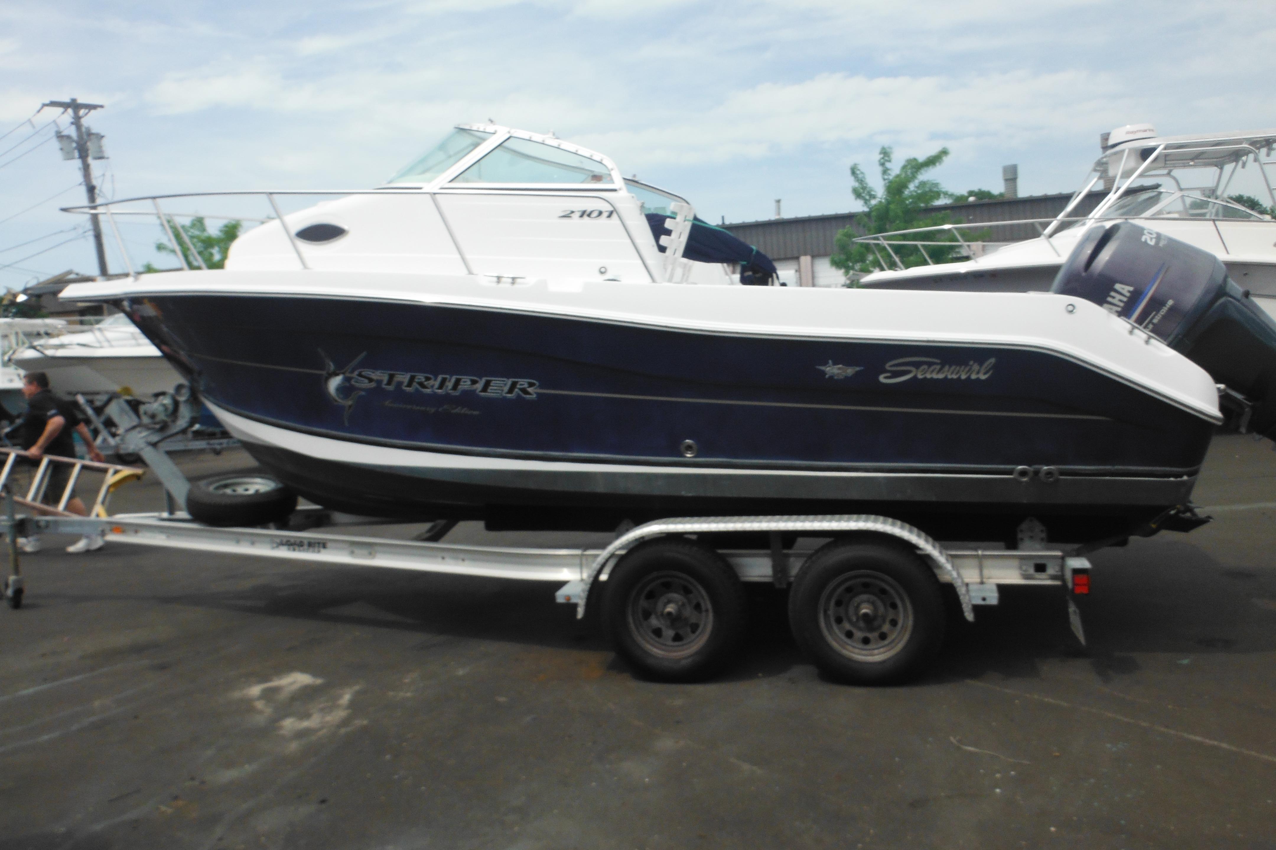 2005 Seaswirl Striper 2101 Walkaround O/B boat on trailer, side view.