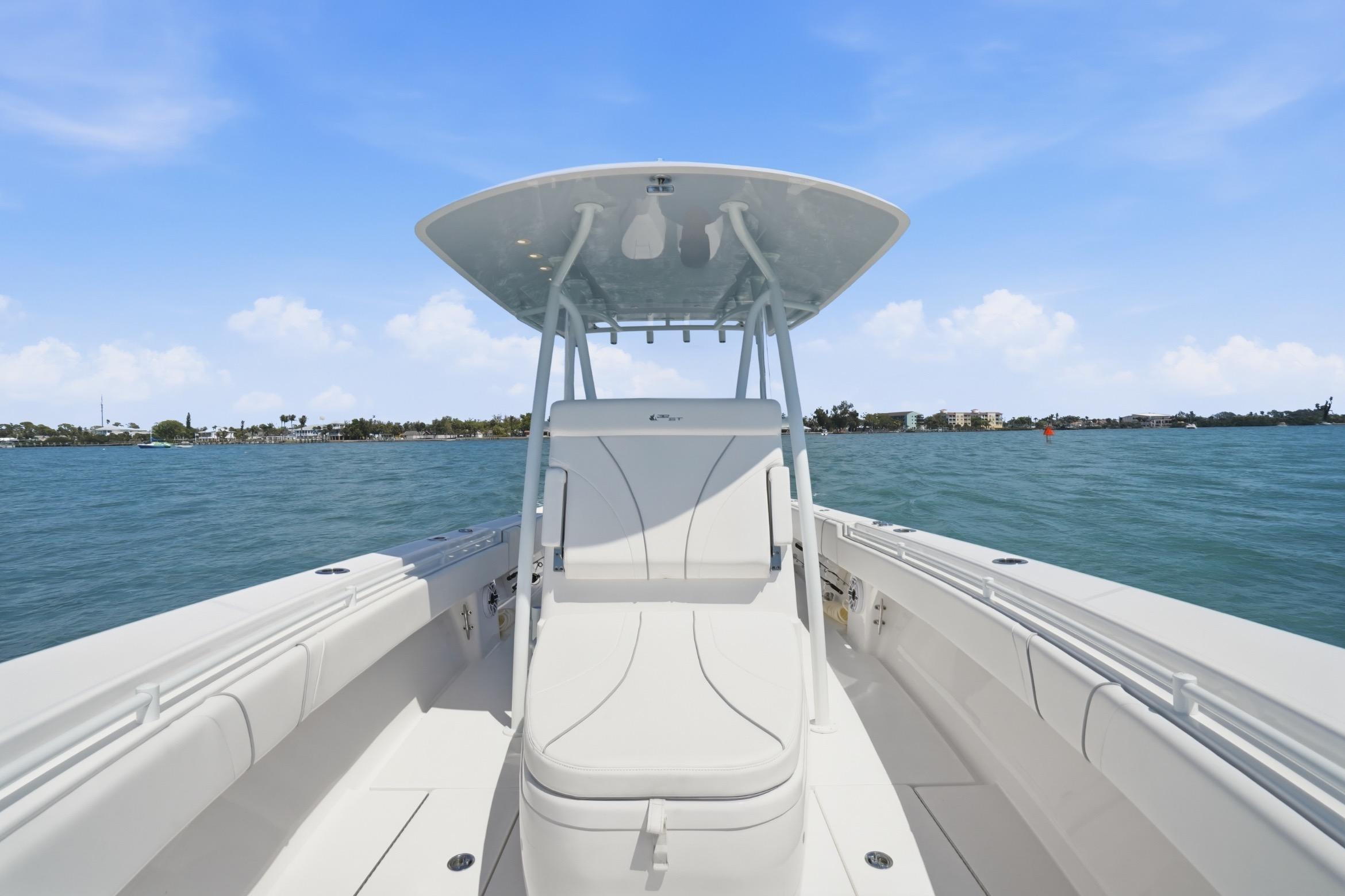 2024 Contender 32 ST boat on water, featuring sleek design and spacious seating.