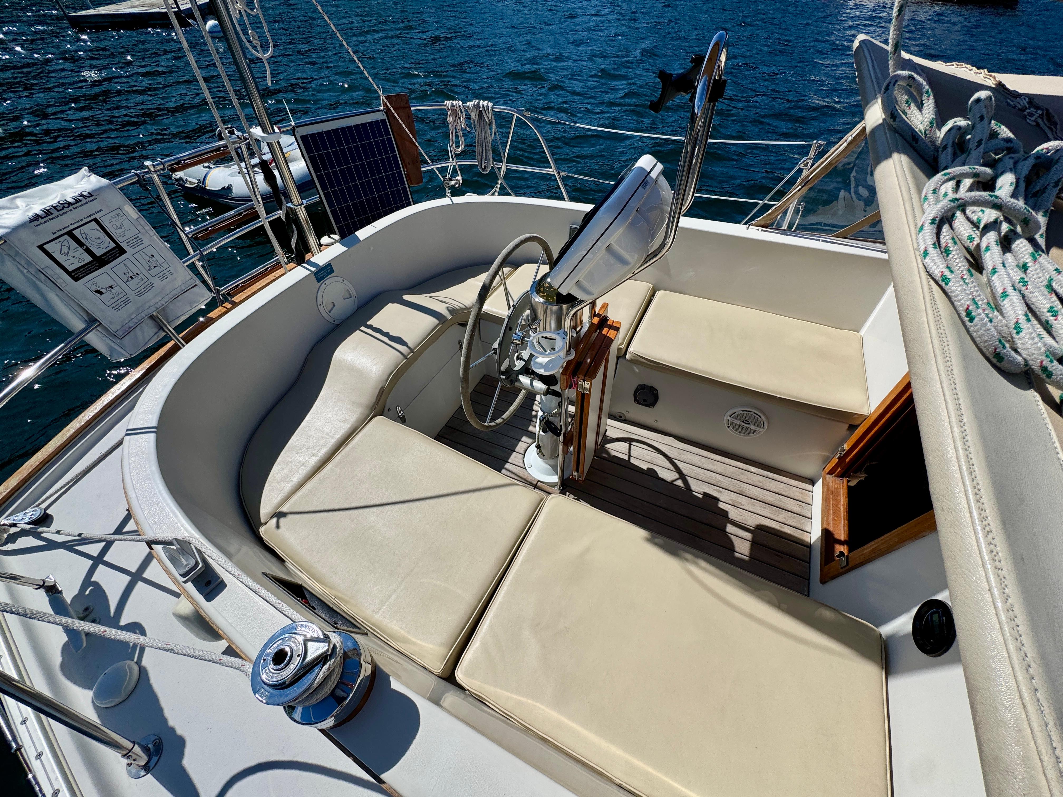 Cockpit of 1989 Nonsuch 30 Ultra sailboat with cushioned seating and steering wheel.