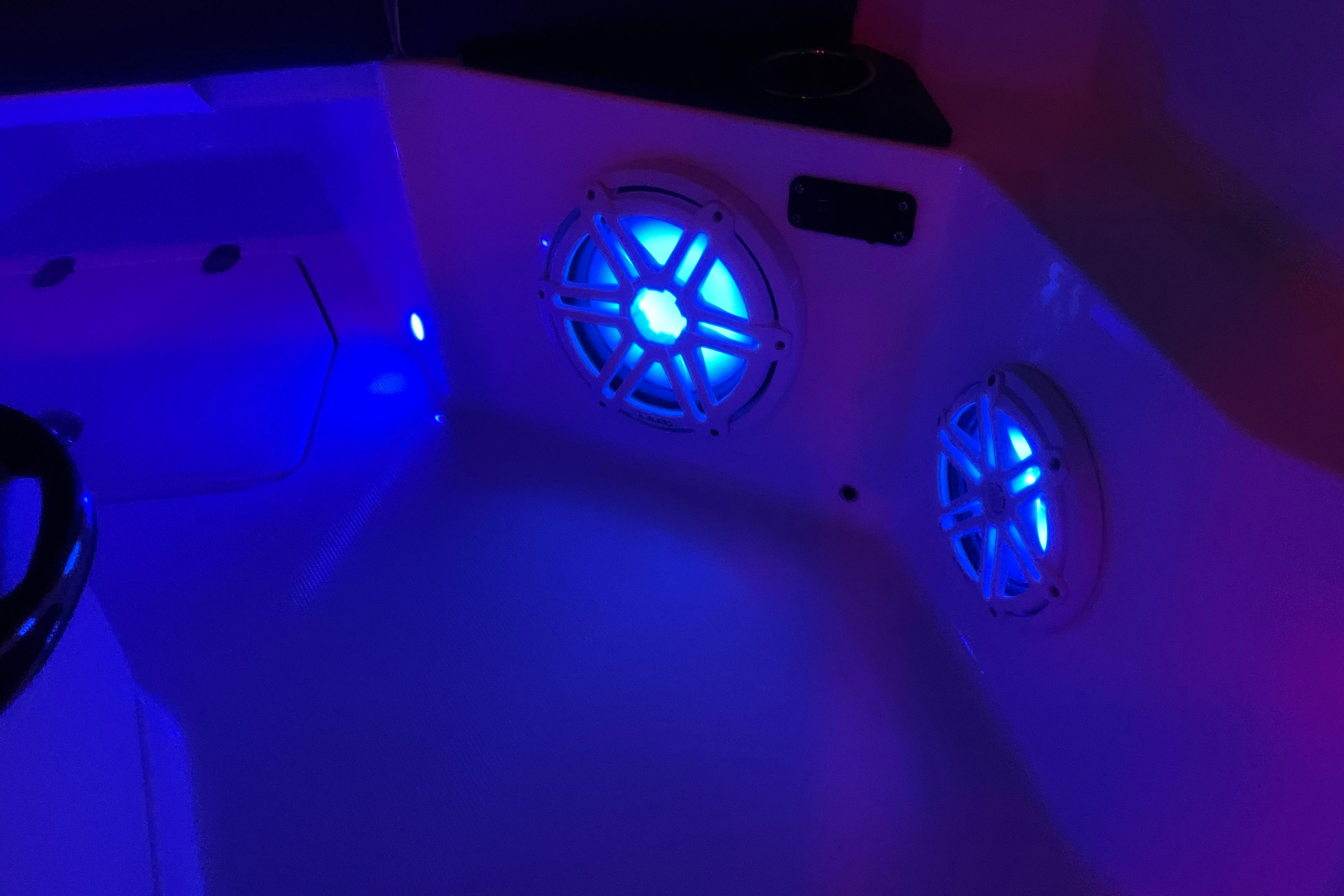 2022 Blackfin 252 CC boat interior with illuminated blue speakers.
