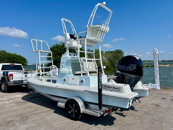 2022 Shallow Sport 20 Classic boat on trailer by the water.
