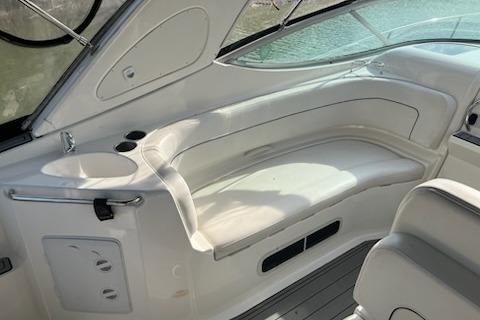 Interior of a 2012 Bayliner 285 Cruiser with white seating and cup holders.