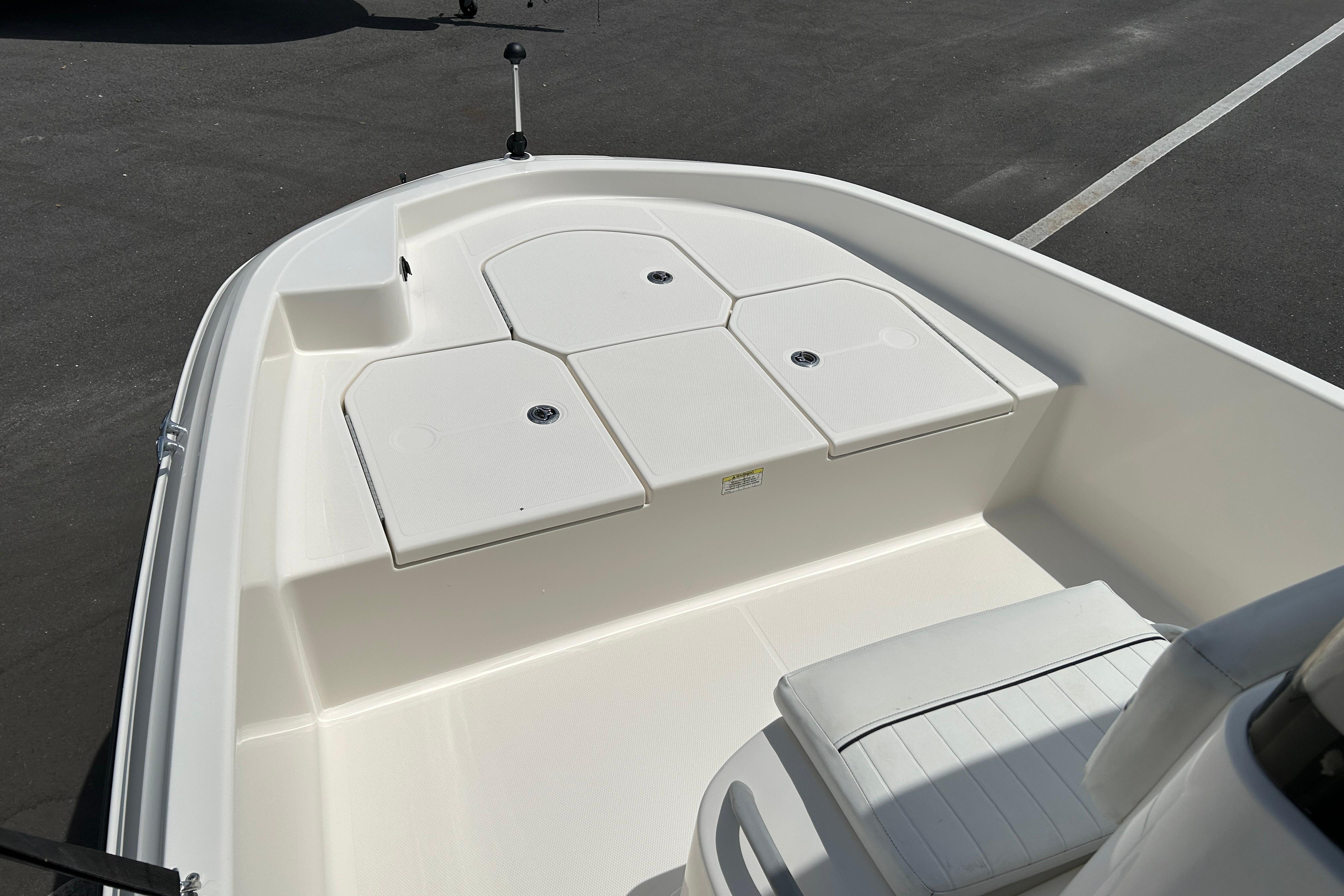 2018 Bayliner Element F16 boat interior with white seating and storage compartments.