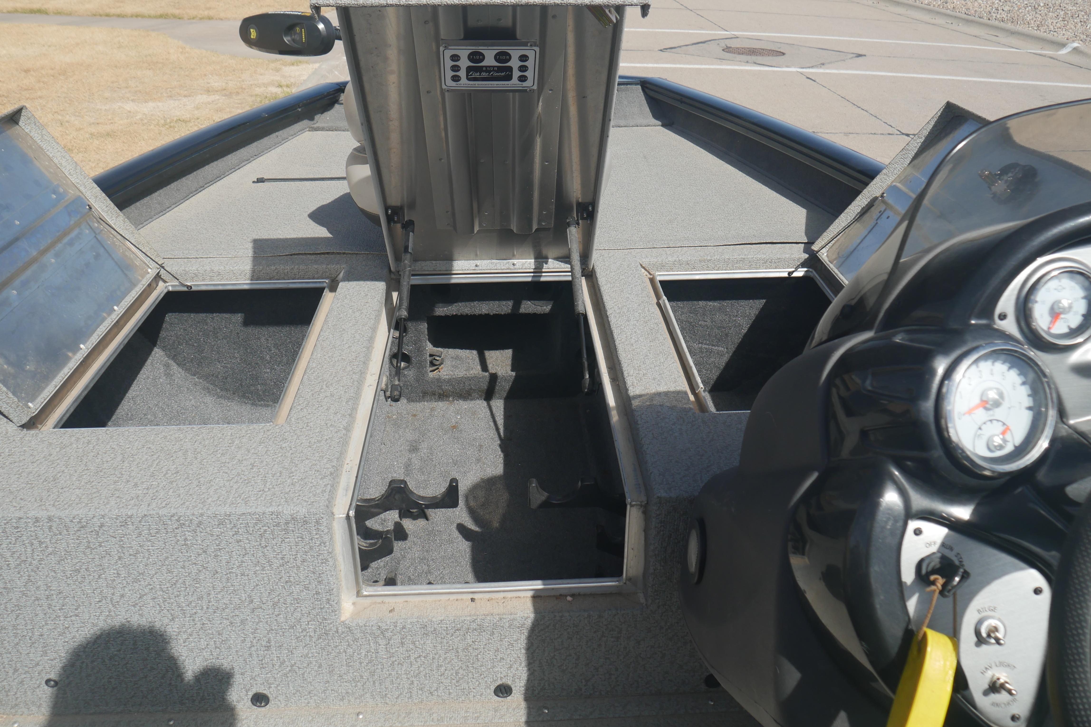 2018 Tracker Pro Team 175 TXW boat interior with open storage compartments and dashboard.
