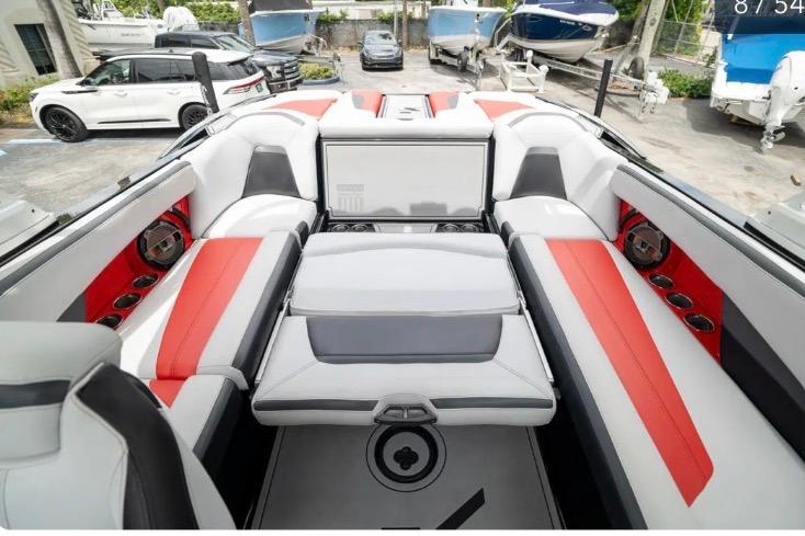 2019 MasterCraft XStar boat interior with red and white seating, parked among other boats.