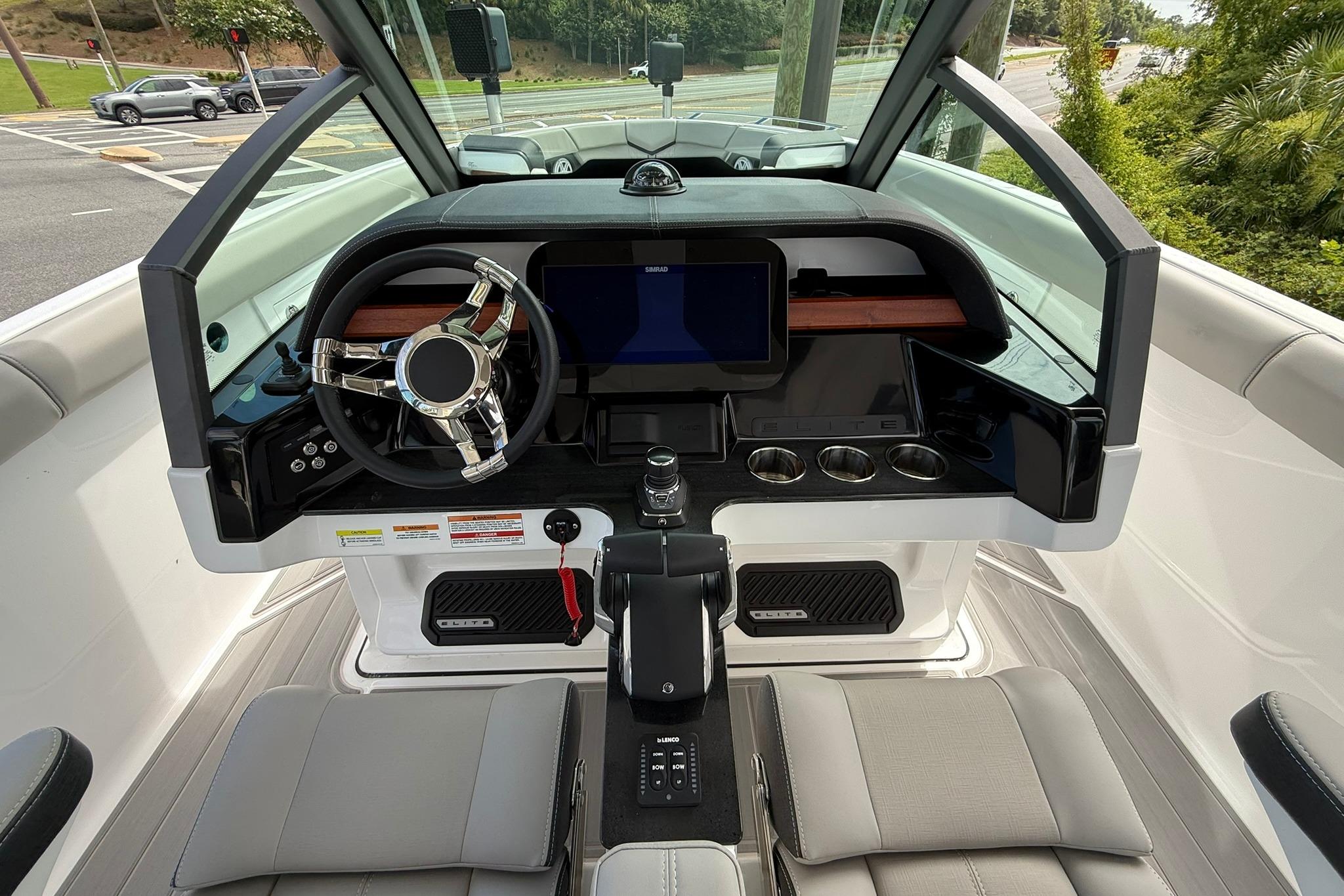 Cockpit of 2027 Monterey Elite 30 OB boat with modern steering and dashboard controls.
