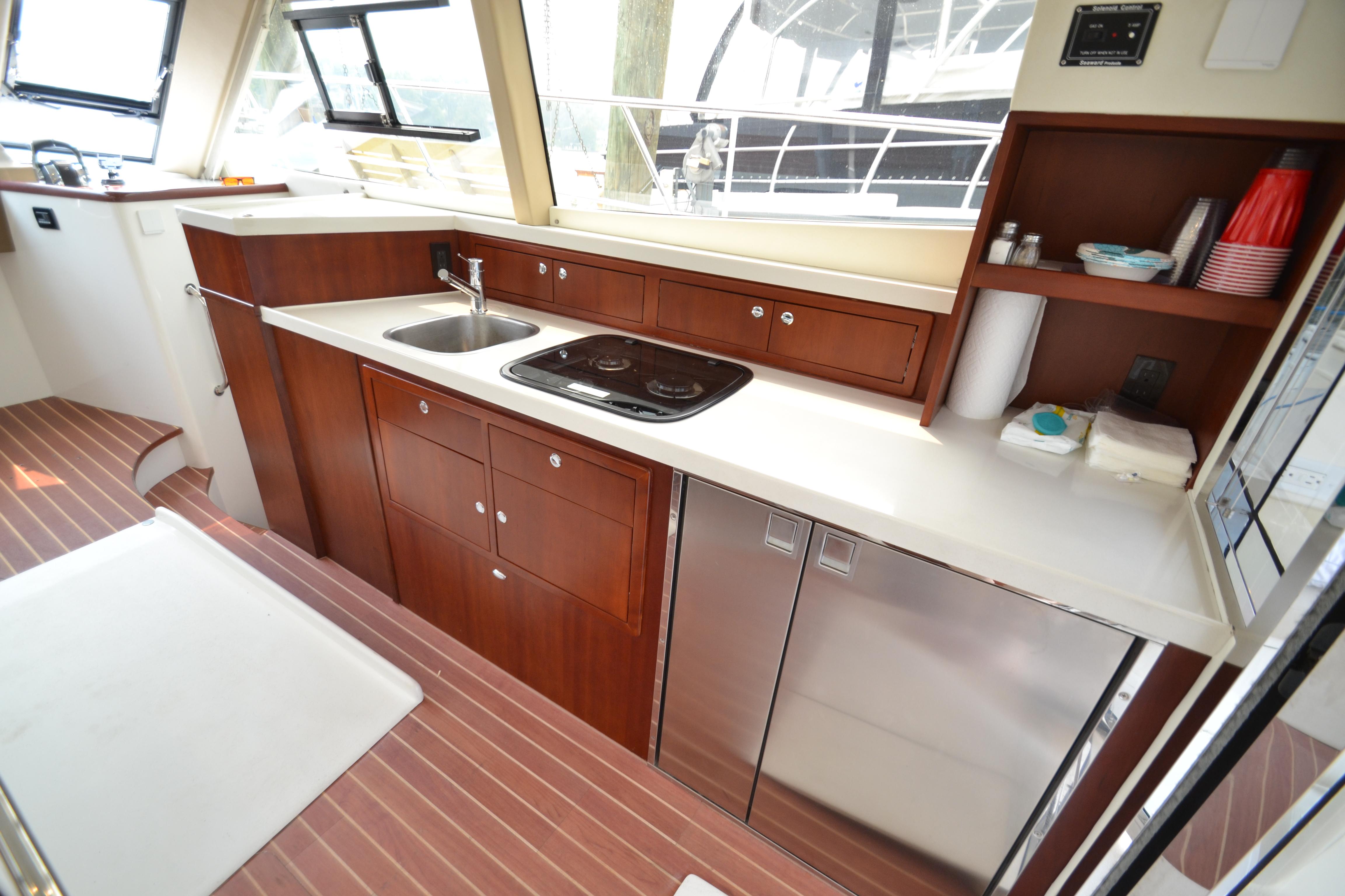 Modern kitchen interior of 2022 ArrowCat 42 Coupe yacht with sleek countertops and appliances.