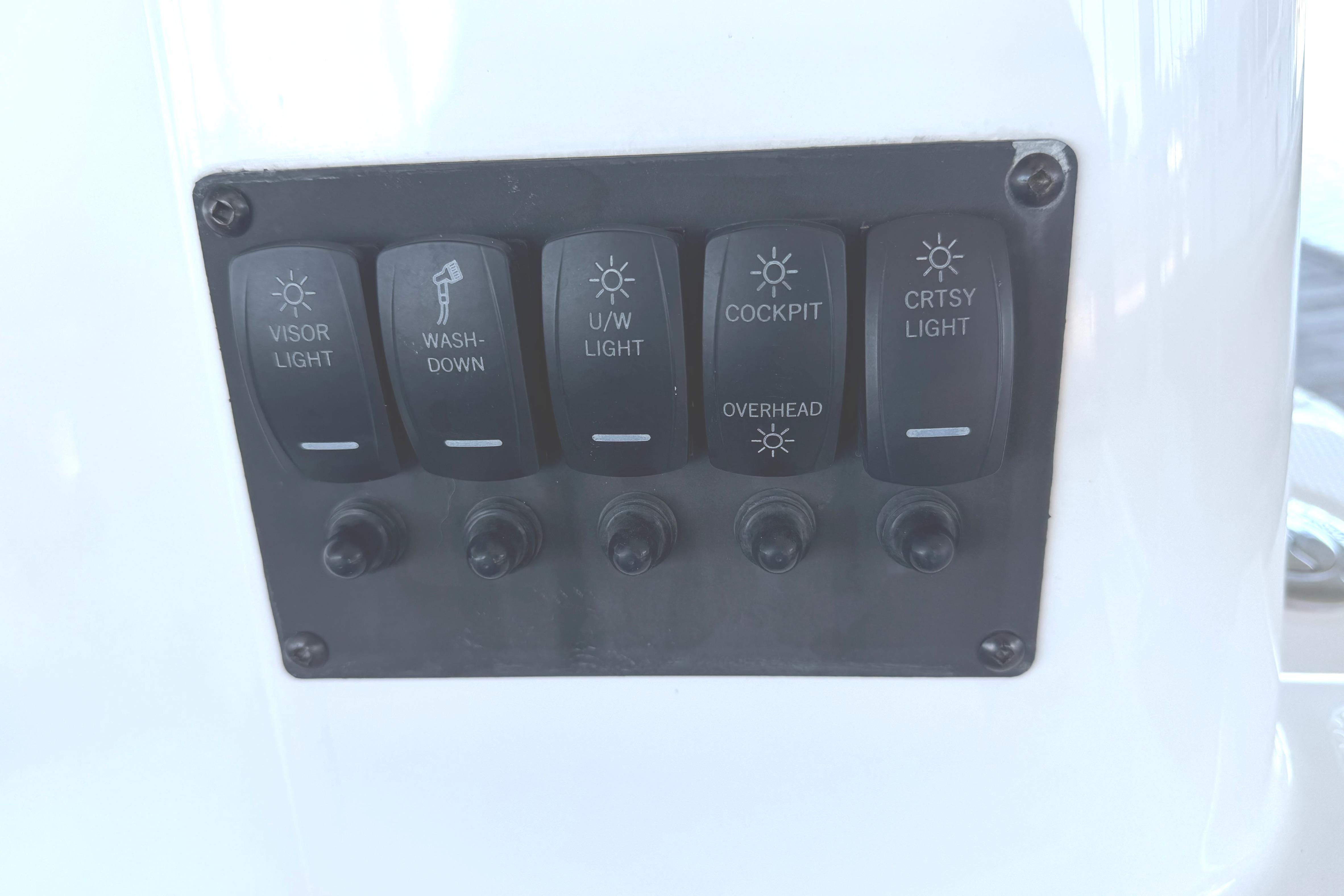 Control panel with light switches on 2023 Cutwater C-288 Coupe boat.