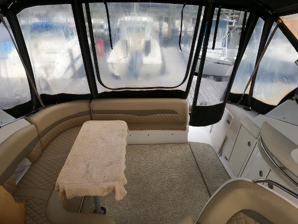 2004 Chaparral Signature 350 interior with seating and table, enclosed by clear panels.