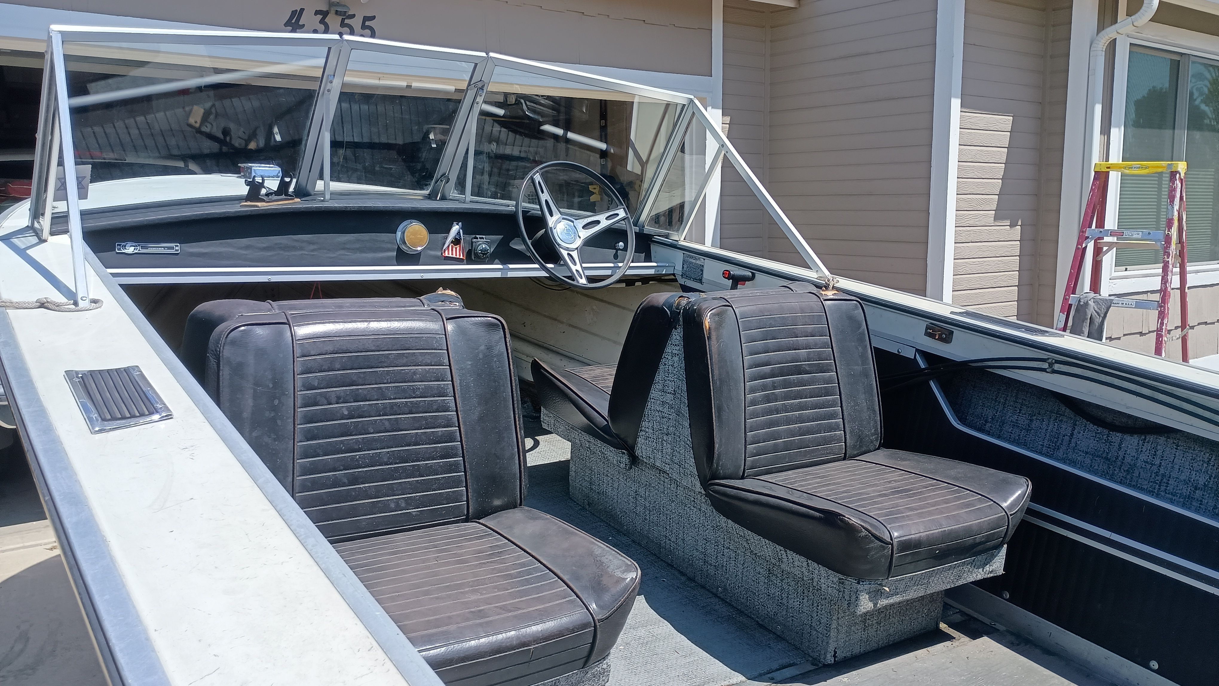 Interior of a 1970 Starcraft Jupiter V boat with black seats.