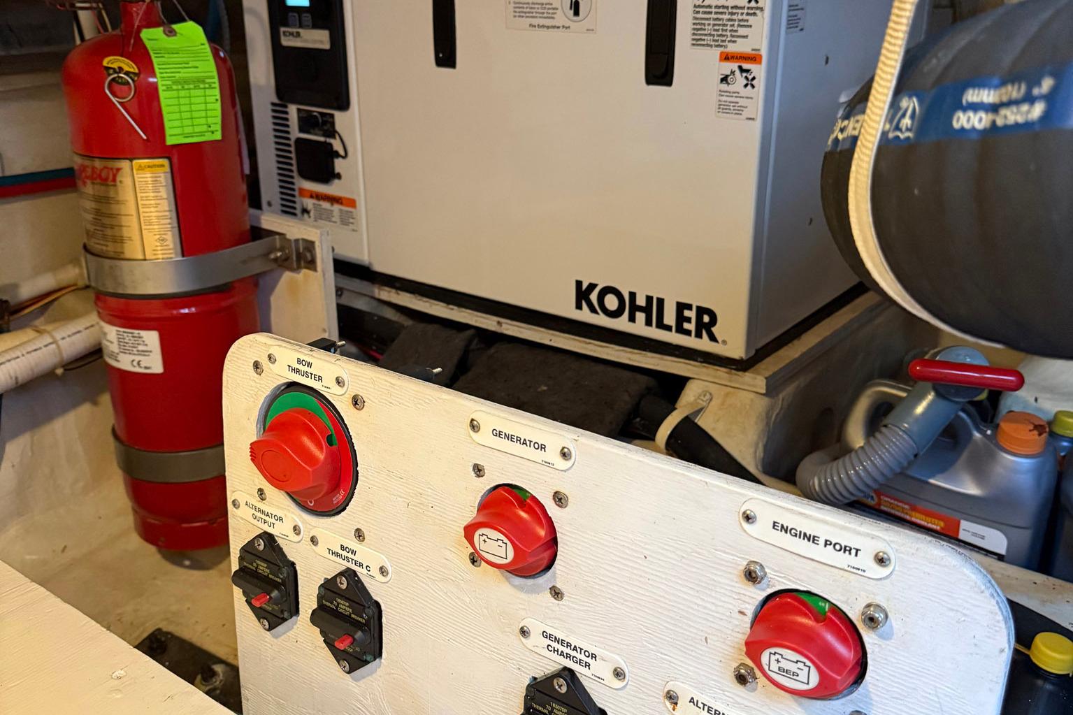 Engine room of 2013 Carver C34 with Kohler generator and fire extinguisher.