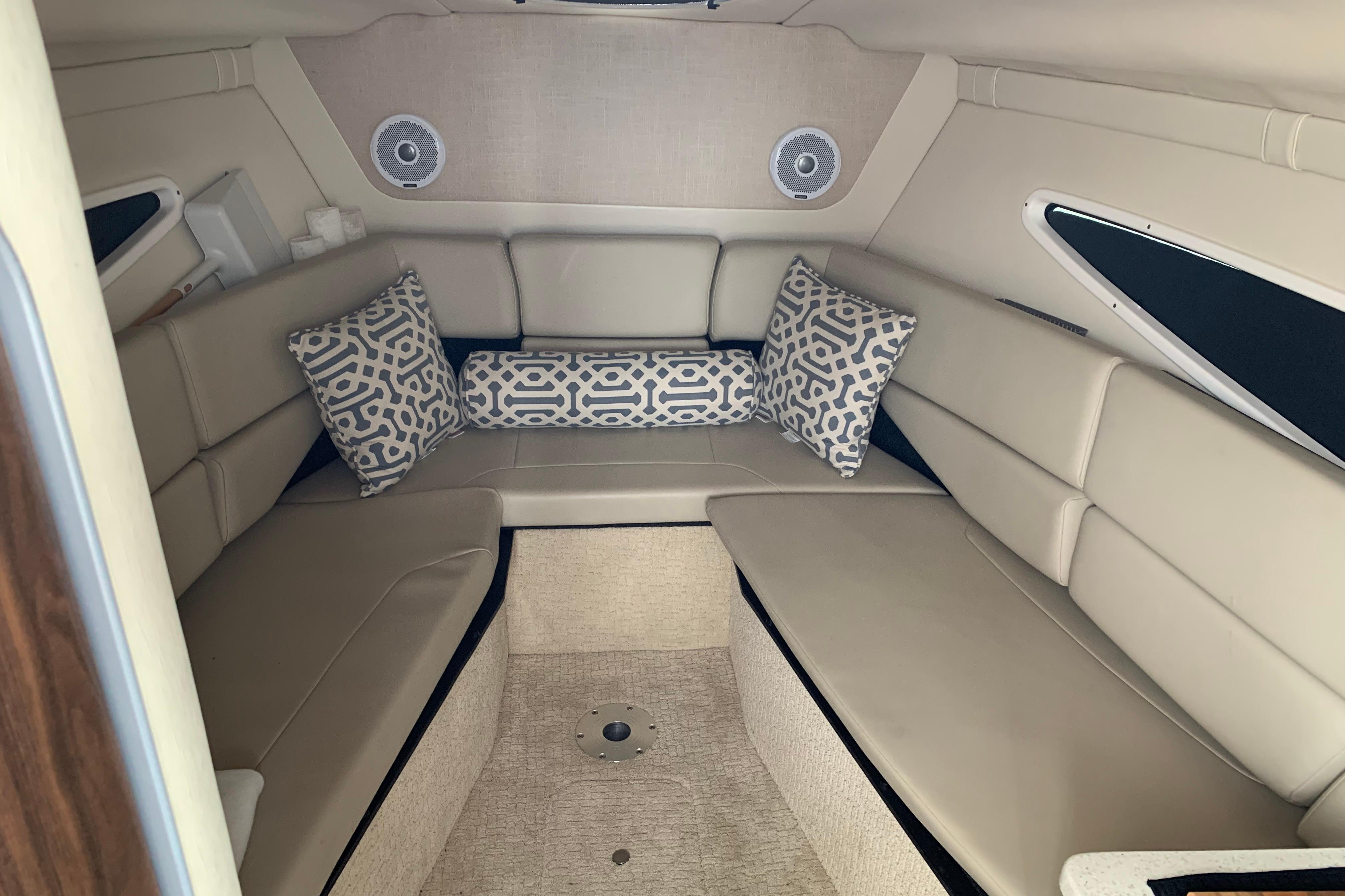 Interior cabin of a 2017 Regal 26 Express boat with beige seating and patterned cushions.
