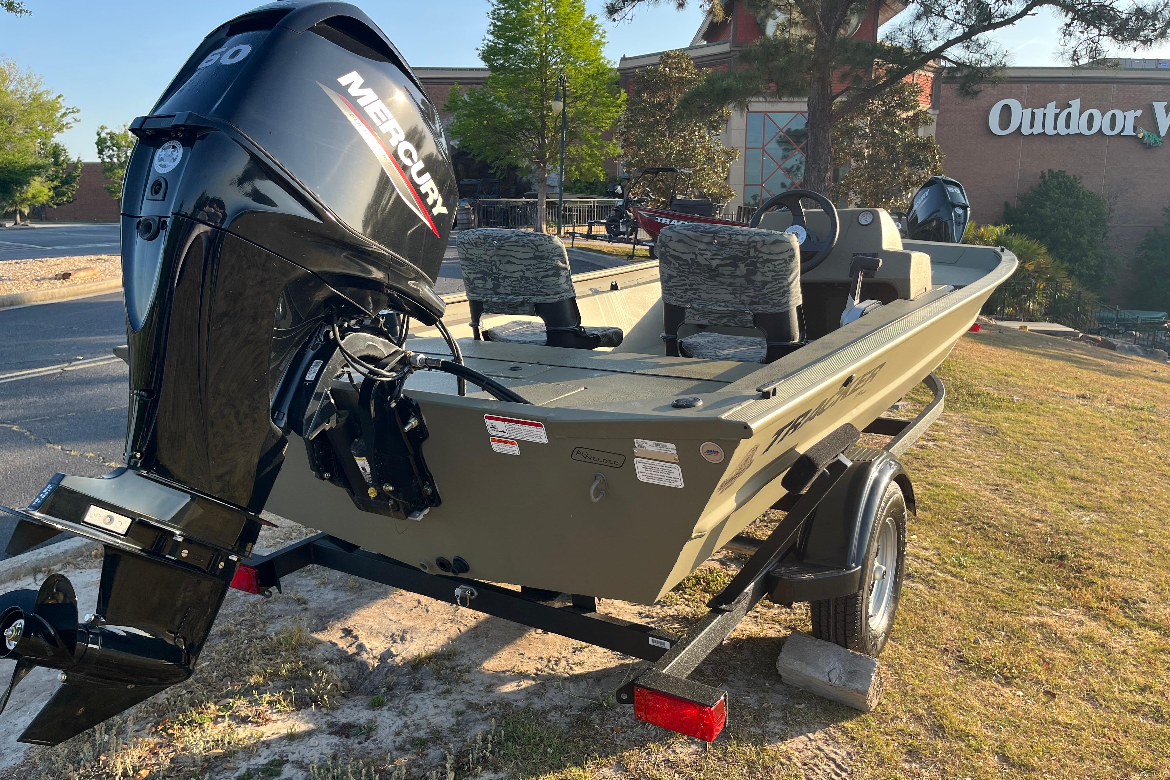 2026 Tracker Grizzly 1754 SC boat with Mercury engine, parked outdoors near Outdoor World.