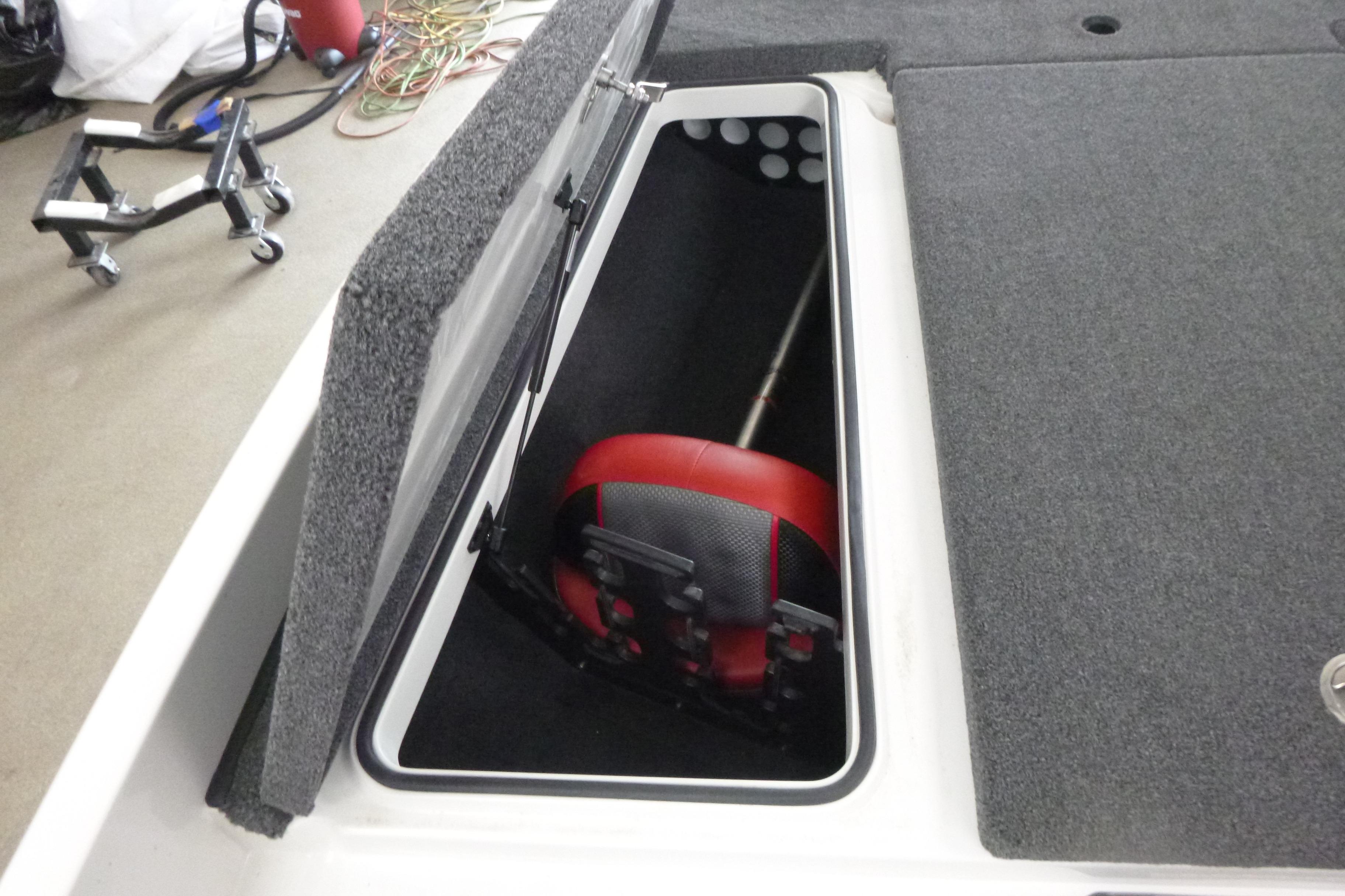 Open storage compartment in 2025 Ranger Z185 boat, showing interior and equipment.