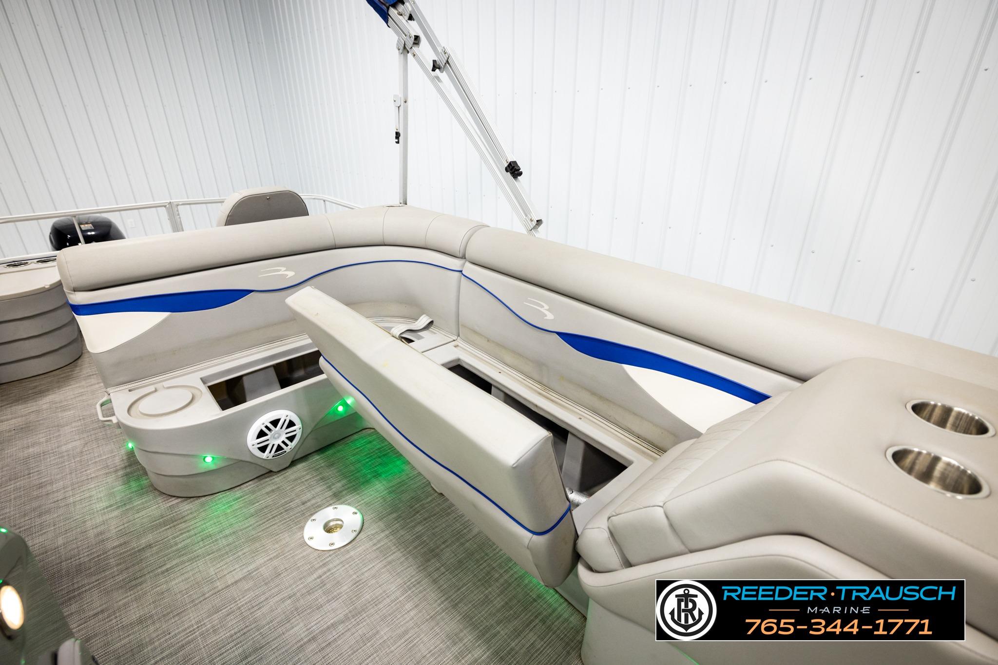 2021 Bennington 20 SV pontoon boat interior with beige seating and blue accents.