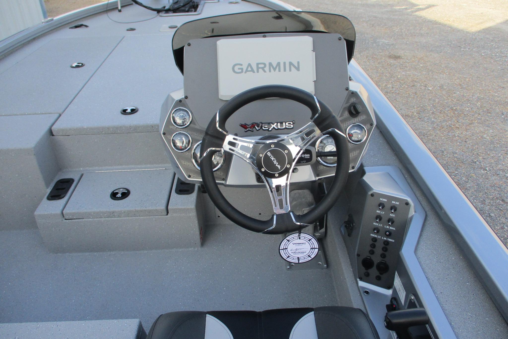 2026 Vexus AVX2080 boat dashboard with Garmin display and steering wheel.