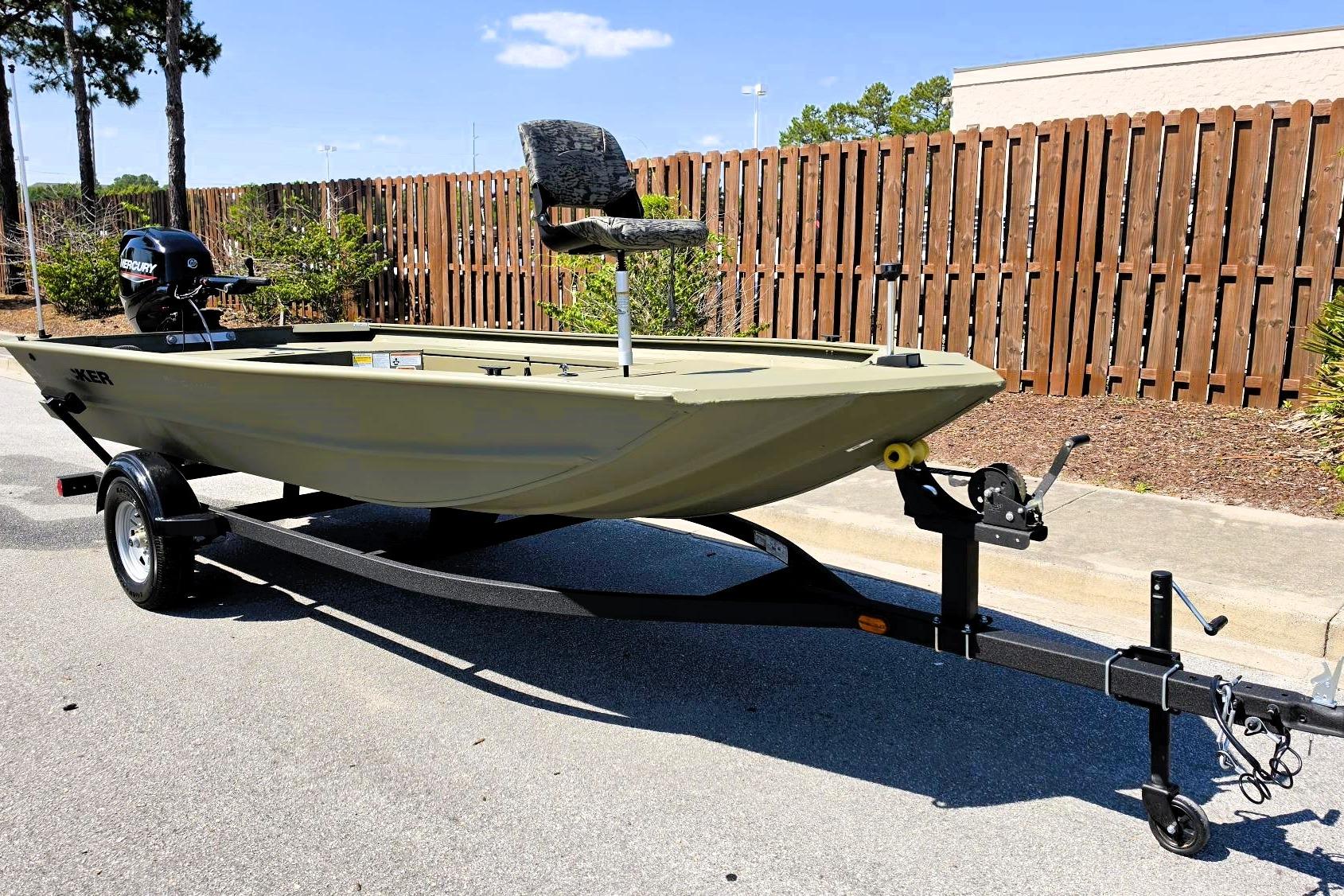 2026 Tracker Grizzly 1654 T Sportsman boat on trailer, parked outdoors.