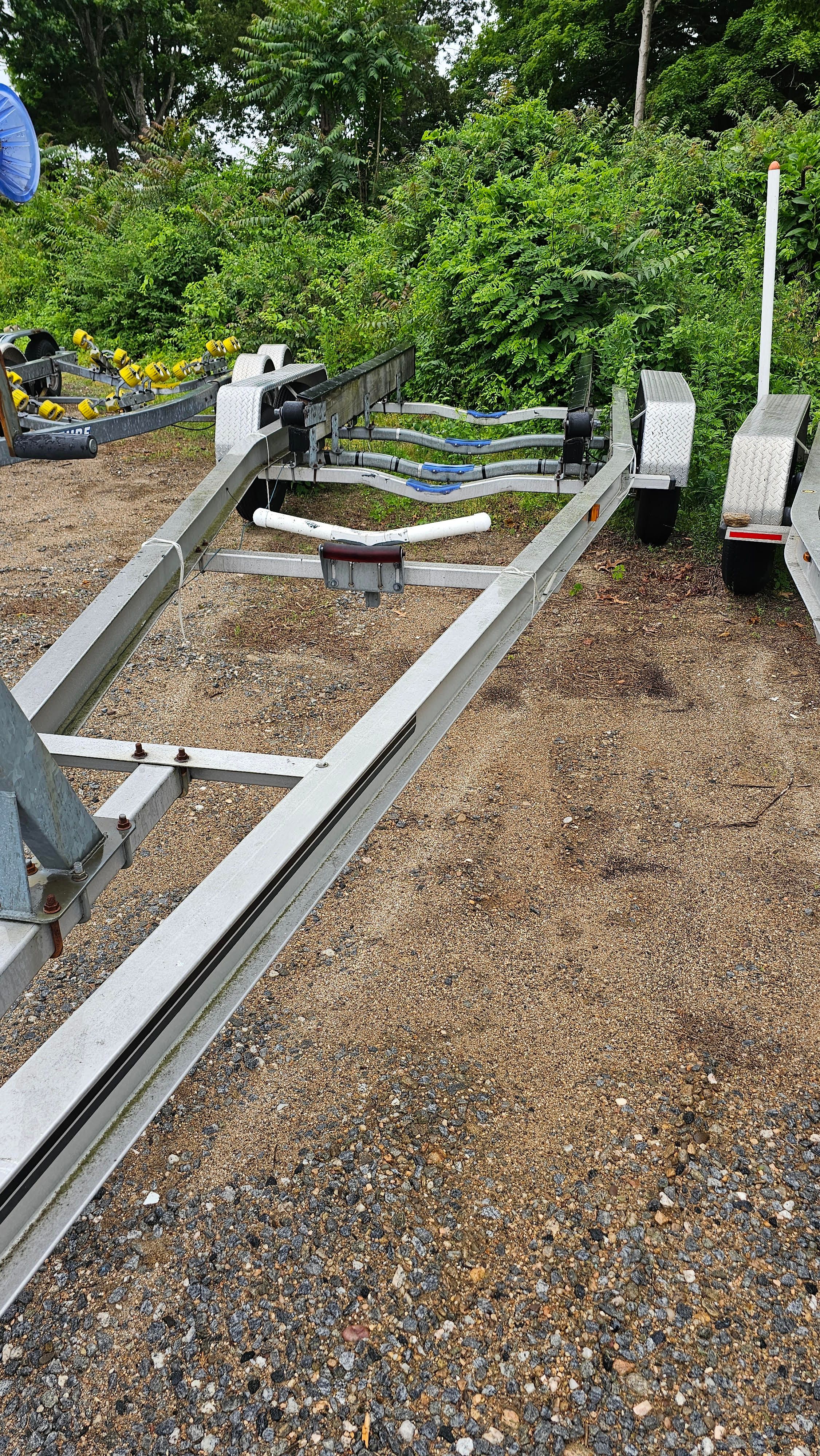 Osprey 26 Expedition boat trailer, 2004 model, on gravel lot.