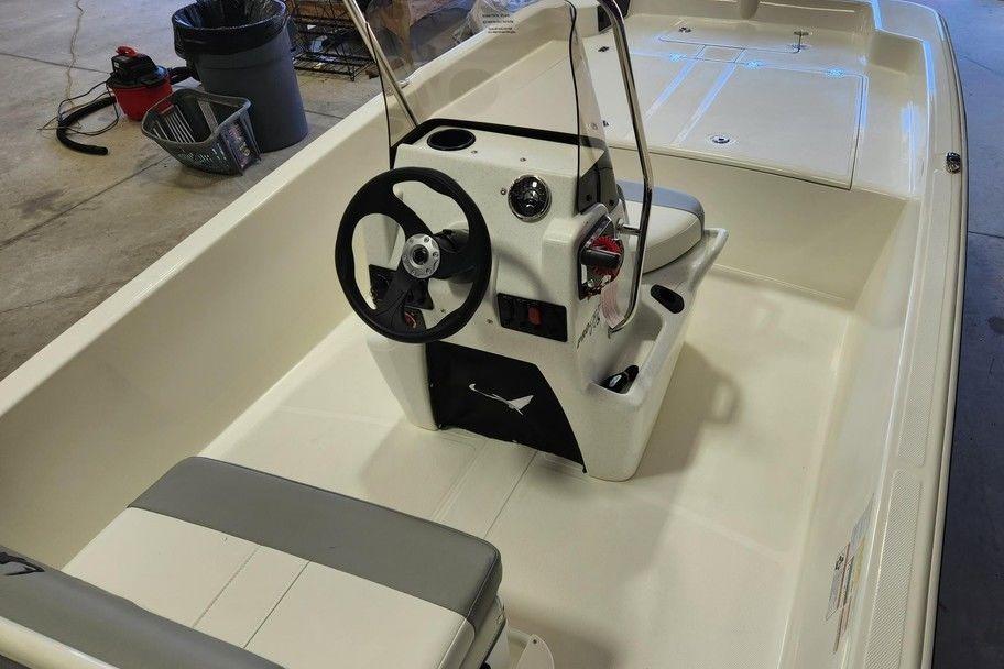 2026 Mako Pro Skiff 17 CC boat interior with steering console and seating.