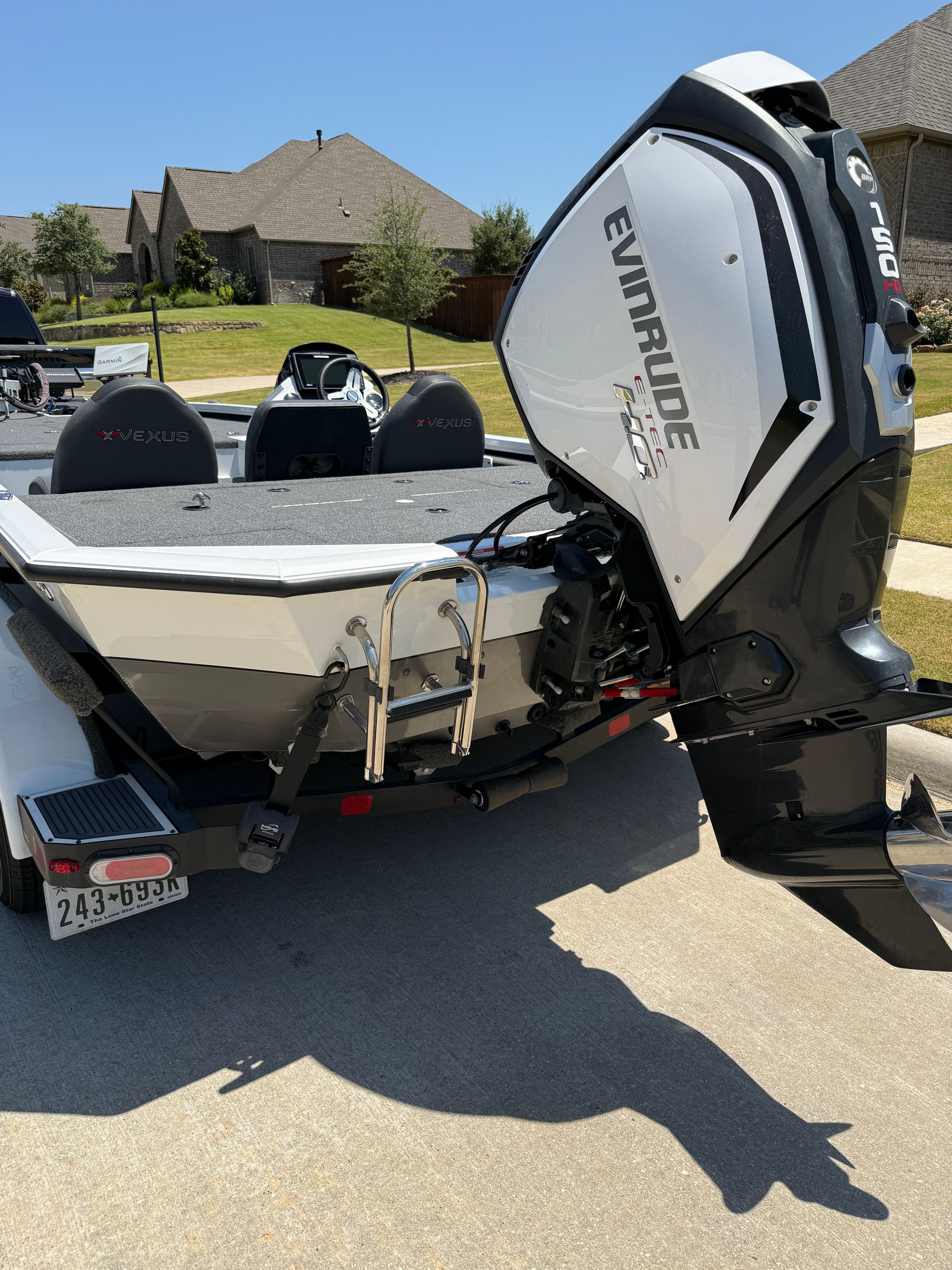 A 2019 Vexus AVX1980 boat with an Evinrude motor, parked on a trailer.