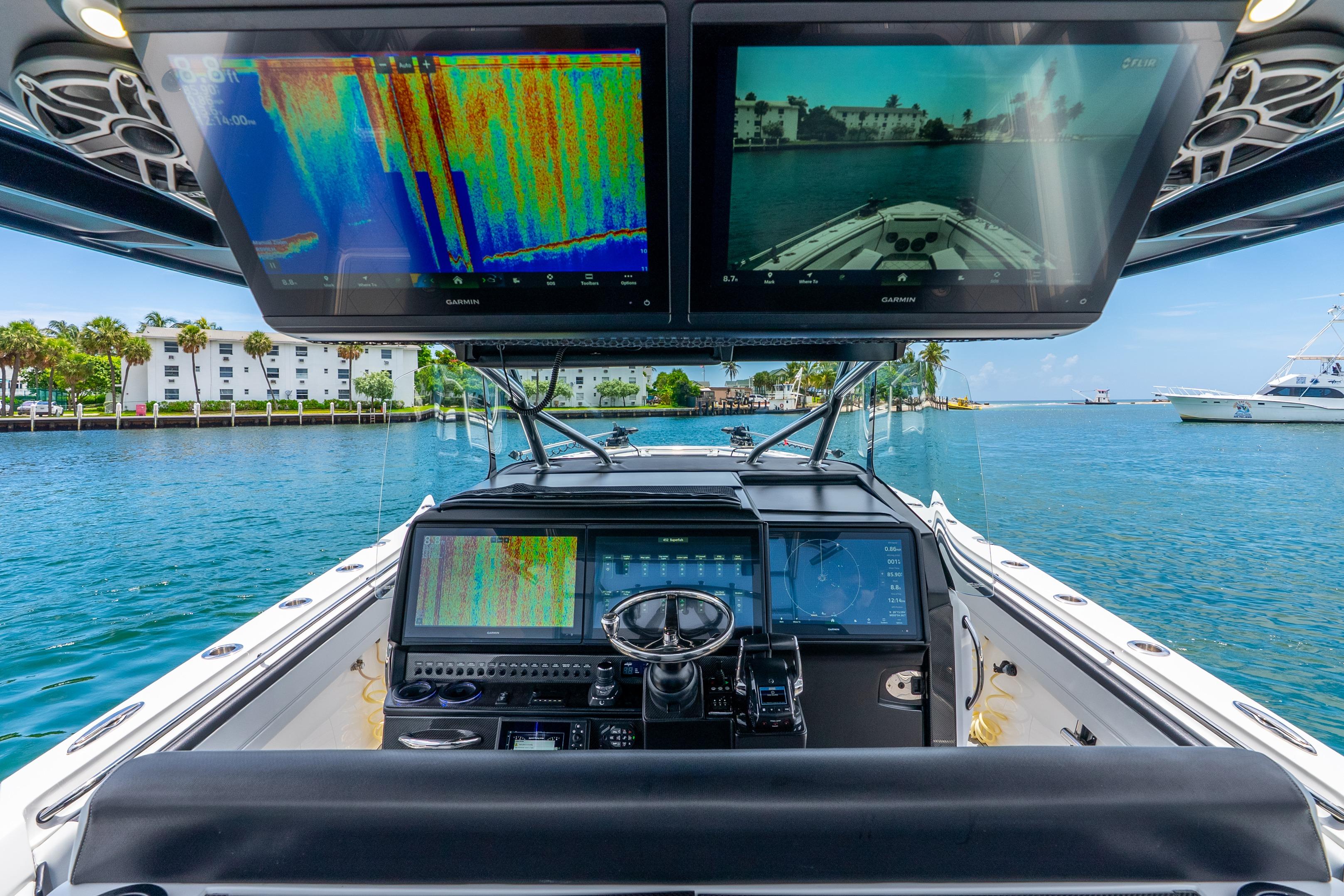 2024 Nor-Tech 452 Super Fish boat cockpit with advanced navigation displays on a sunny day.