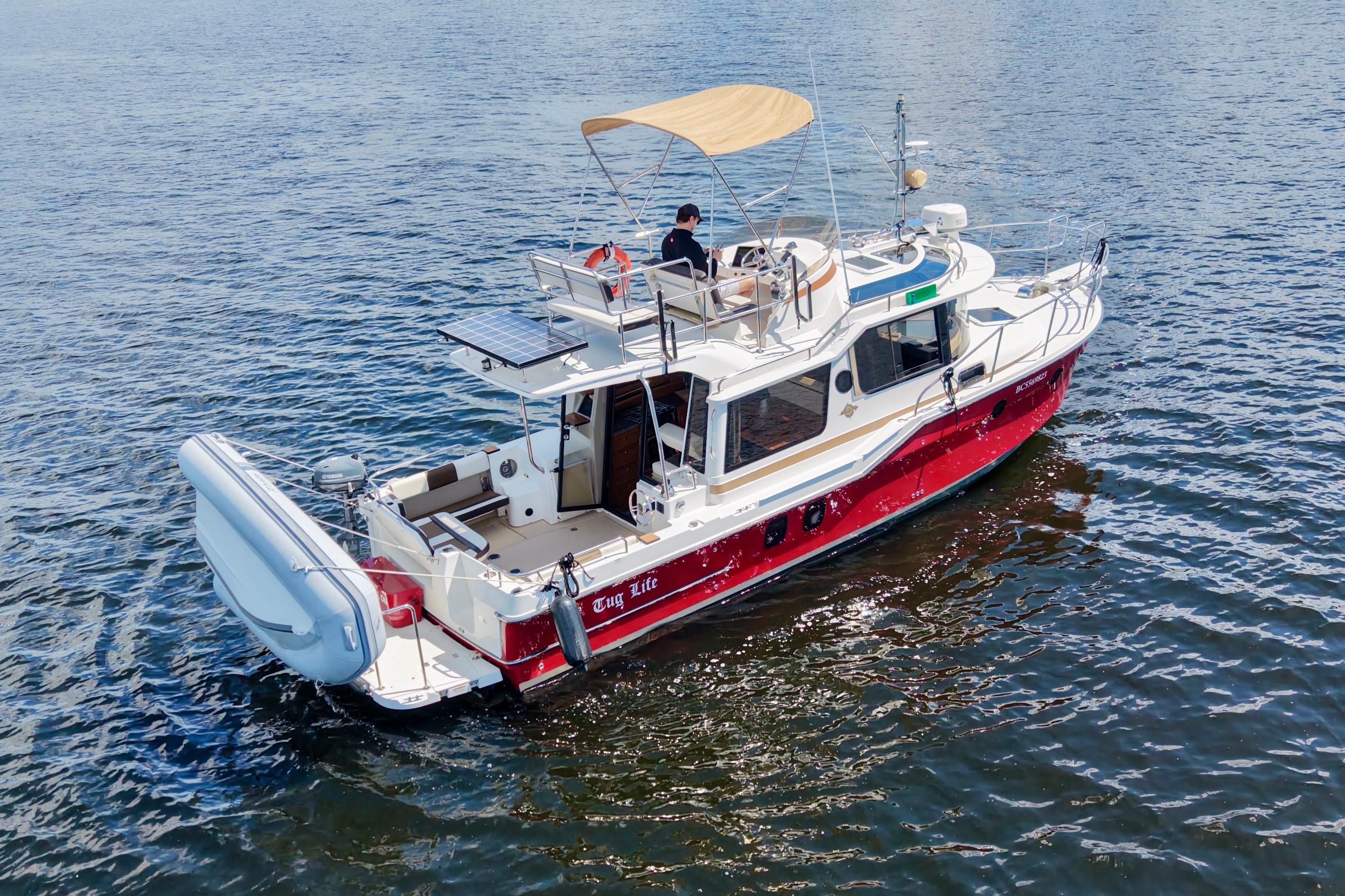 2017 Ranger Tugs R-29 CB boat with canopy cruising on open water.