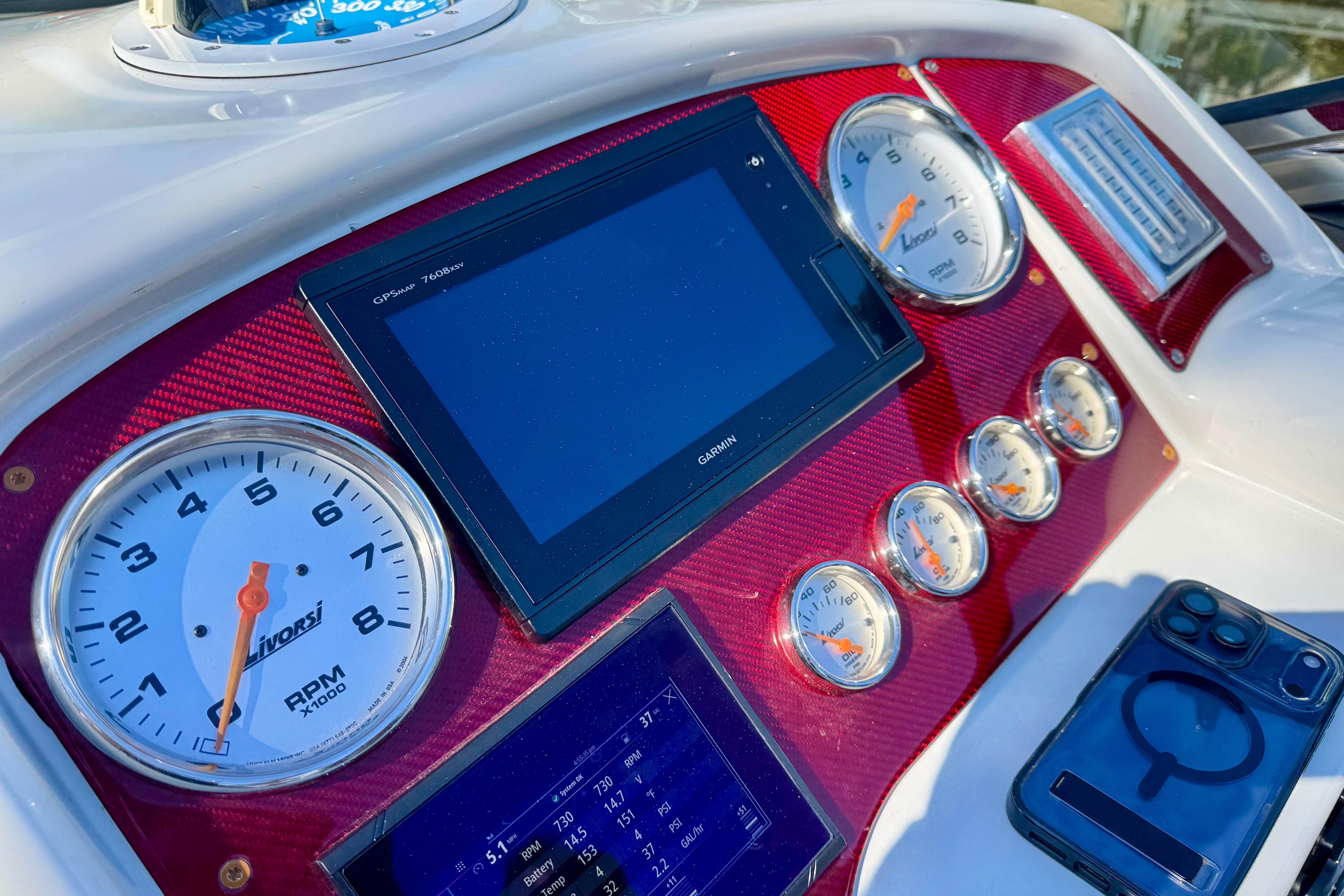 Dashboard of a 2006 Formula 382 FASTech boat with gauges and Garmin display.