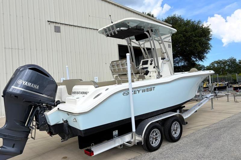 2024 Key West 239 FS boat on trailer with Yamaha engine, parked near a building.