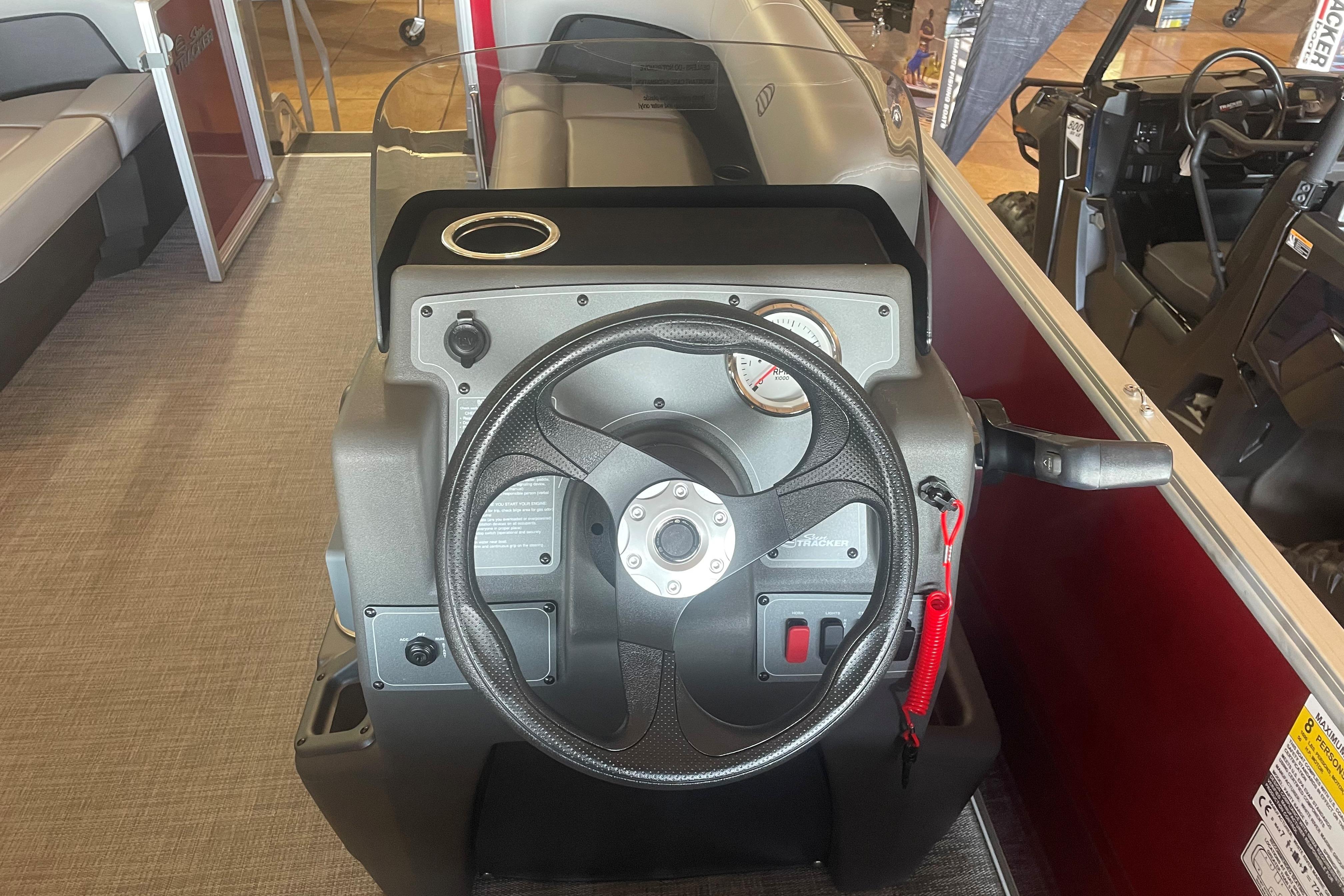 2026 Sun Tracker Party Barge 16 DLX steering console with gauges and controls.