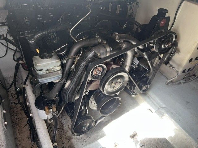 Engine compartment of a 1999 Doral 300sc with visible belts and hoses.