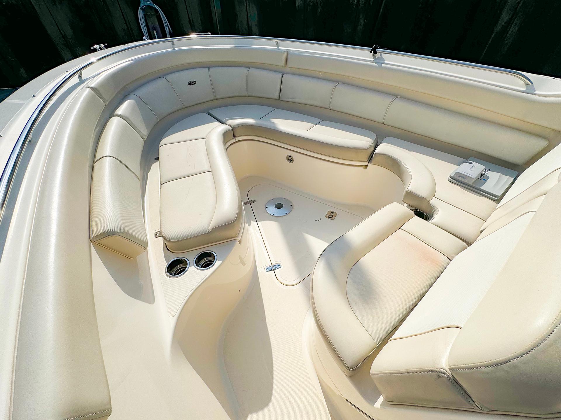 2014 Pursuit ST 310 Sport boat interior with beige seating and cup holders.
