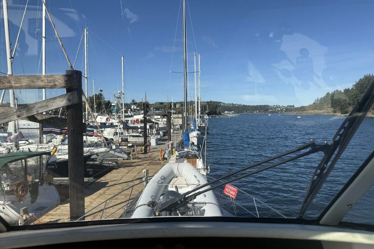 View from Royal Pacific 476 Sport Cruiser, docked at a marina, clear blue sky.