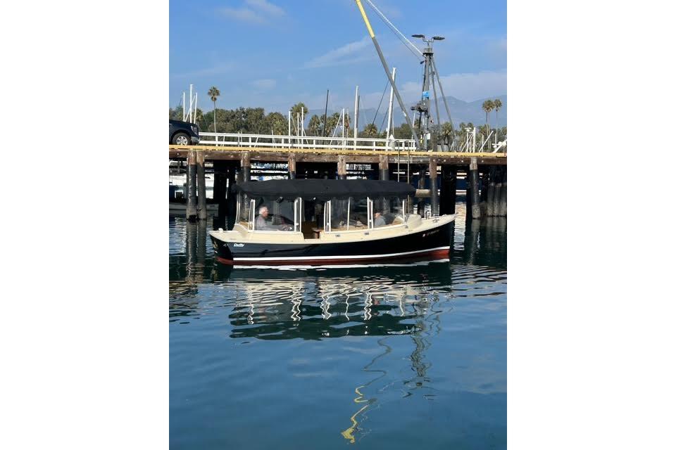 2007 Duffy 22 Cuddy boat docked in a marina with calm water reflections.