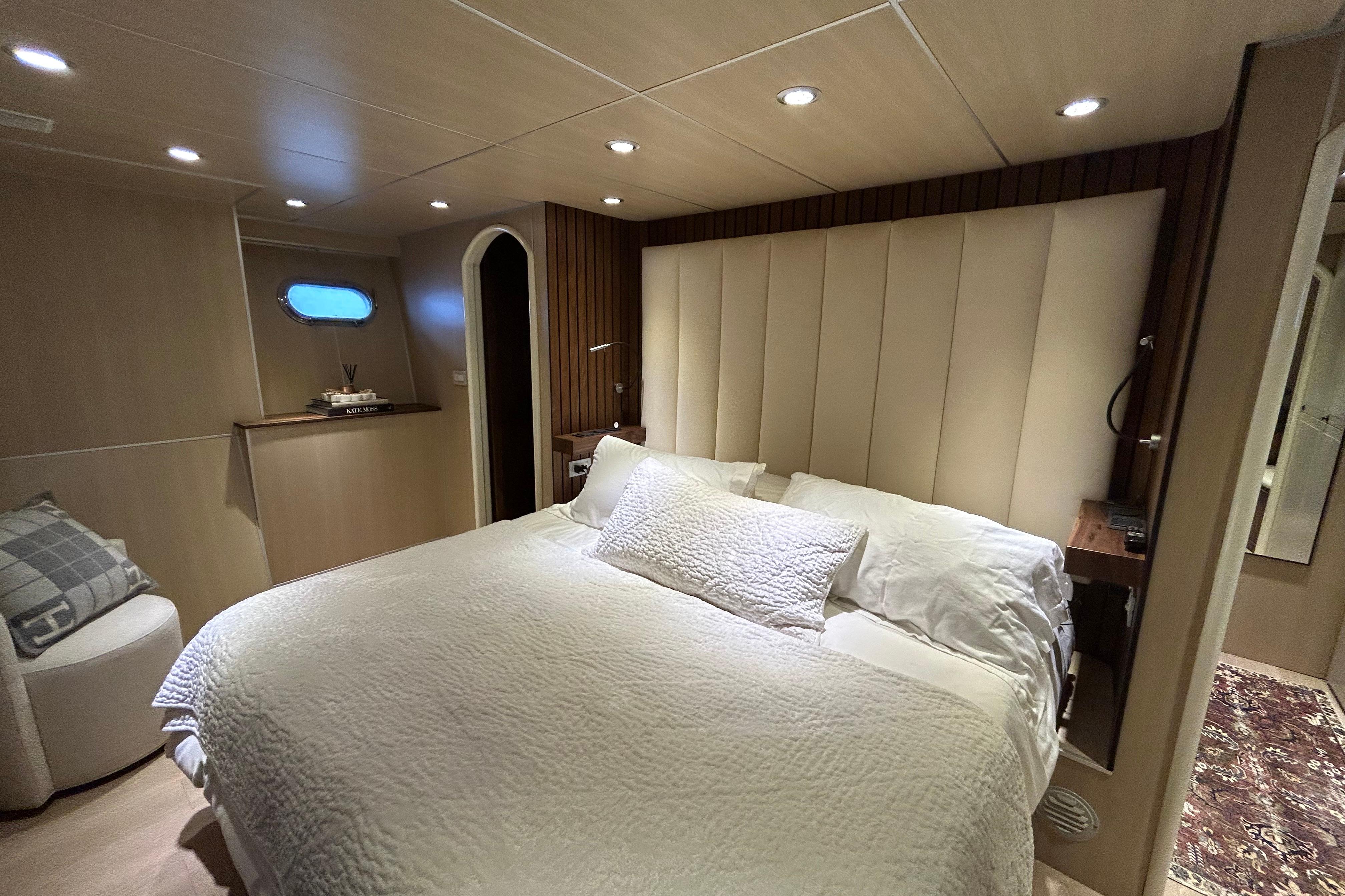 Luxurious bedroom interior of 2002 Cheoy Lee 66 Pilothouse yacht with elegant lighting.
