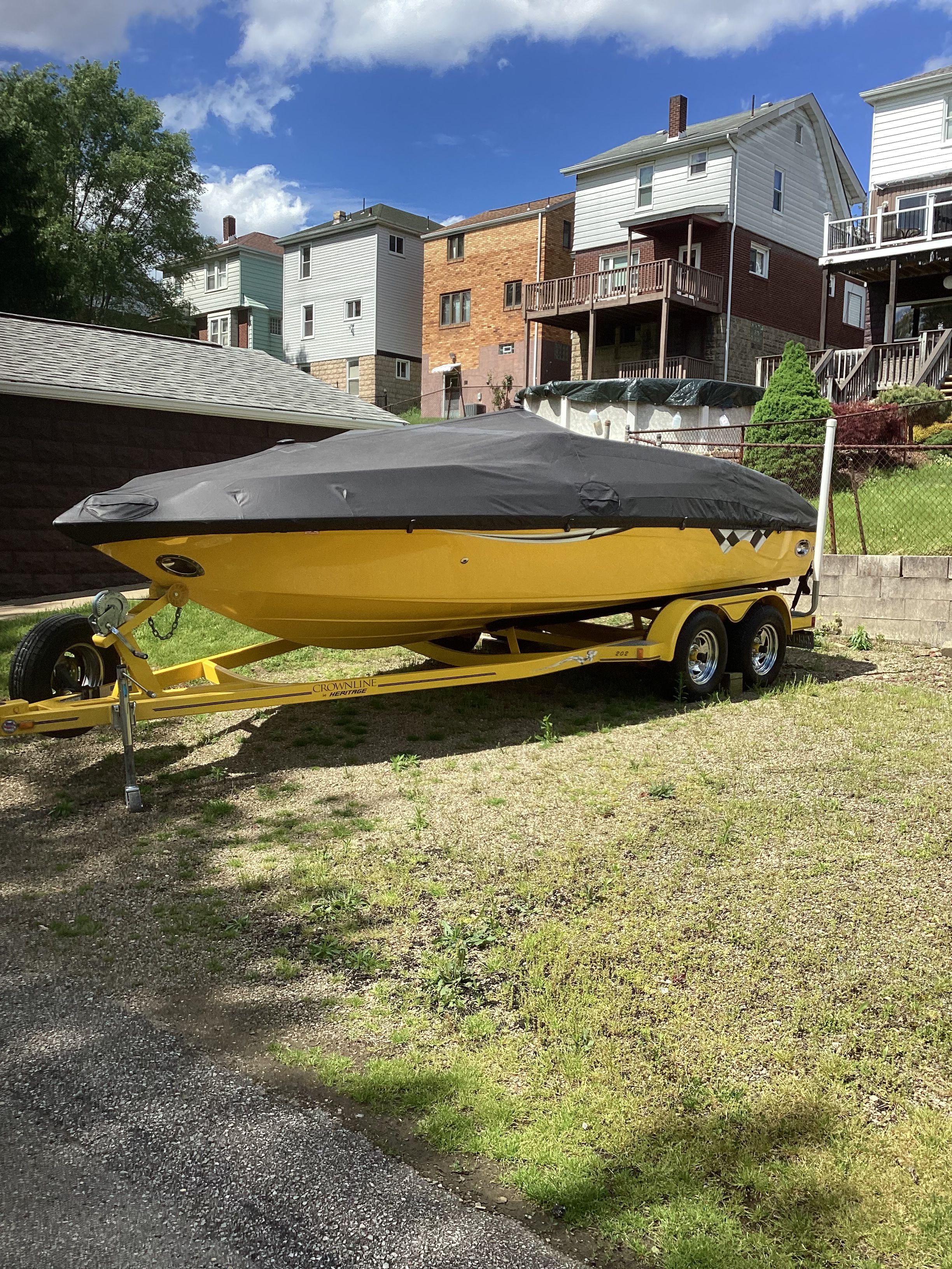 Yellow 2005 Crownline 202 BR LPX boat on trailer outdoors.