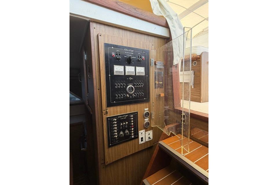 Electrical control panel inside a 1980 Chris-Craft 381 Catalina boat, featuring switches and gauges.
