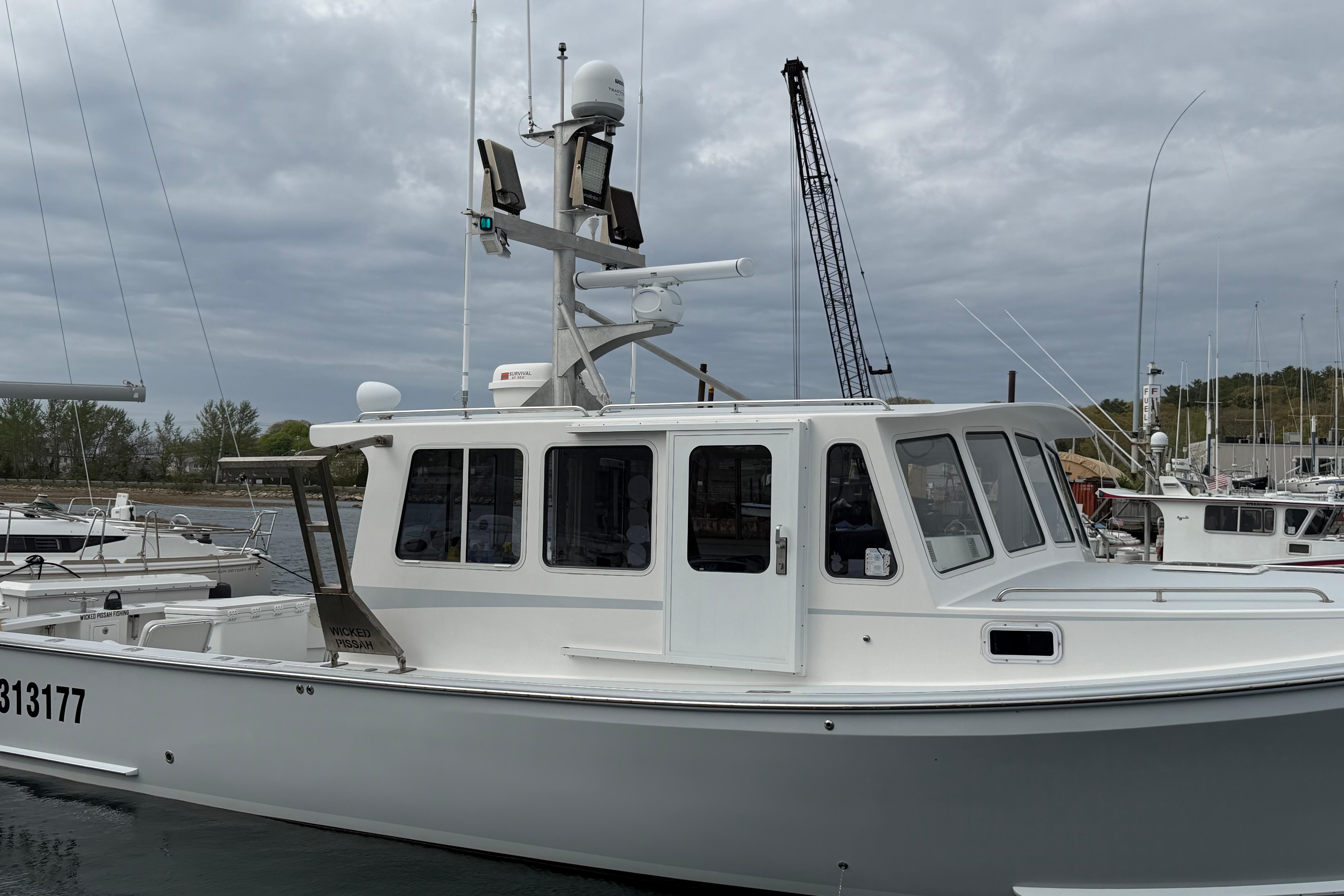 2018 H&H Marine Osmond Beal boat docked at marina under cloudy sky.