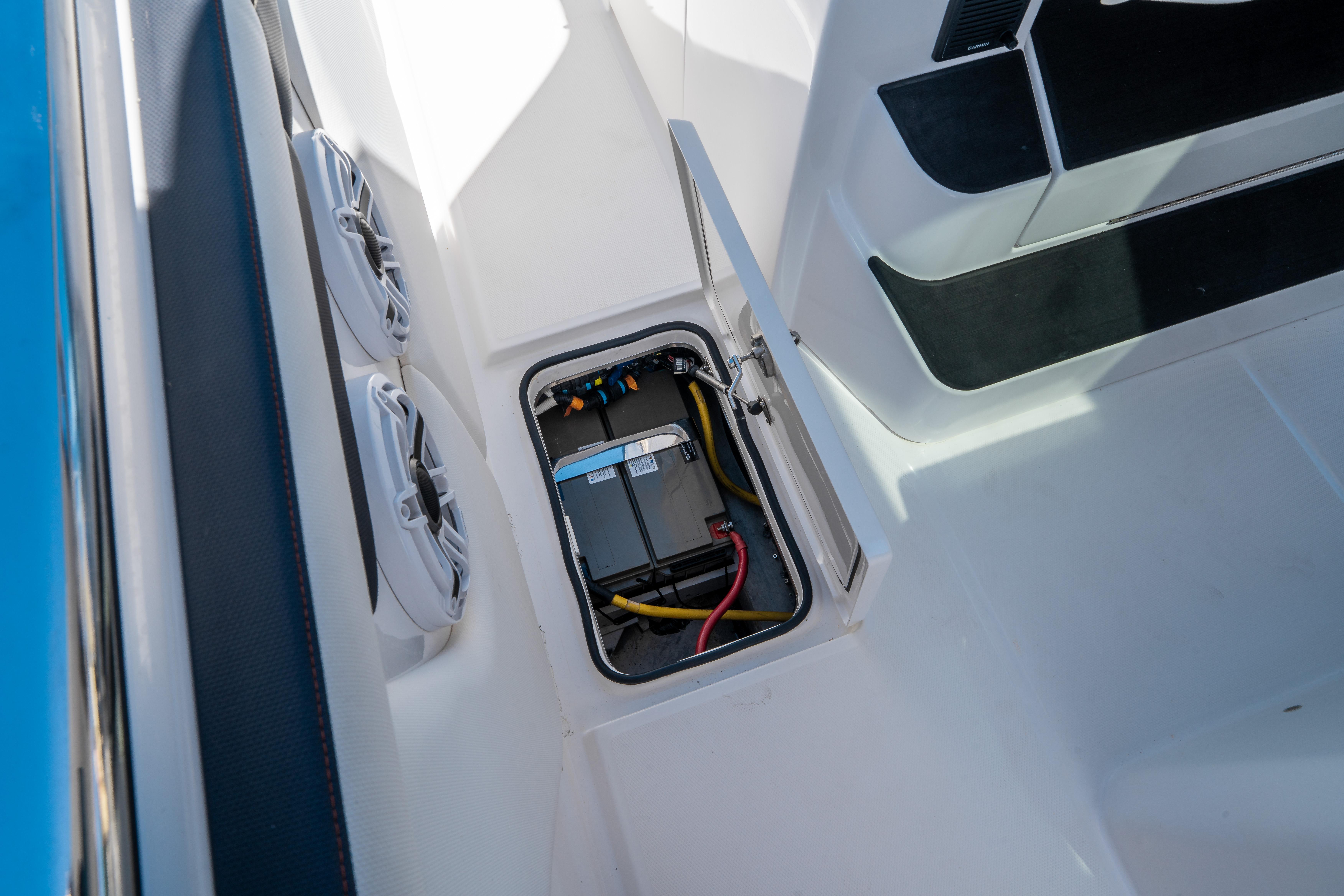 2021 Cigarette 59 Tirranna boat battery compartment with wiring and open hatch.