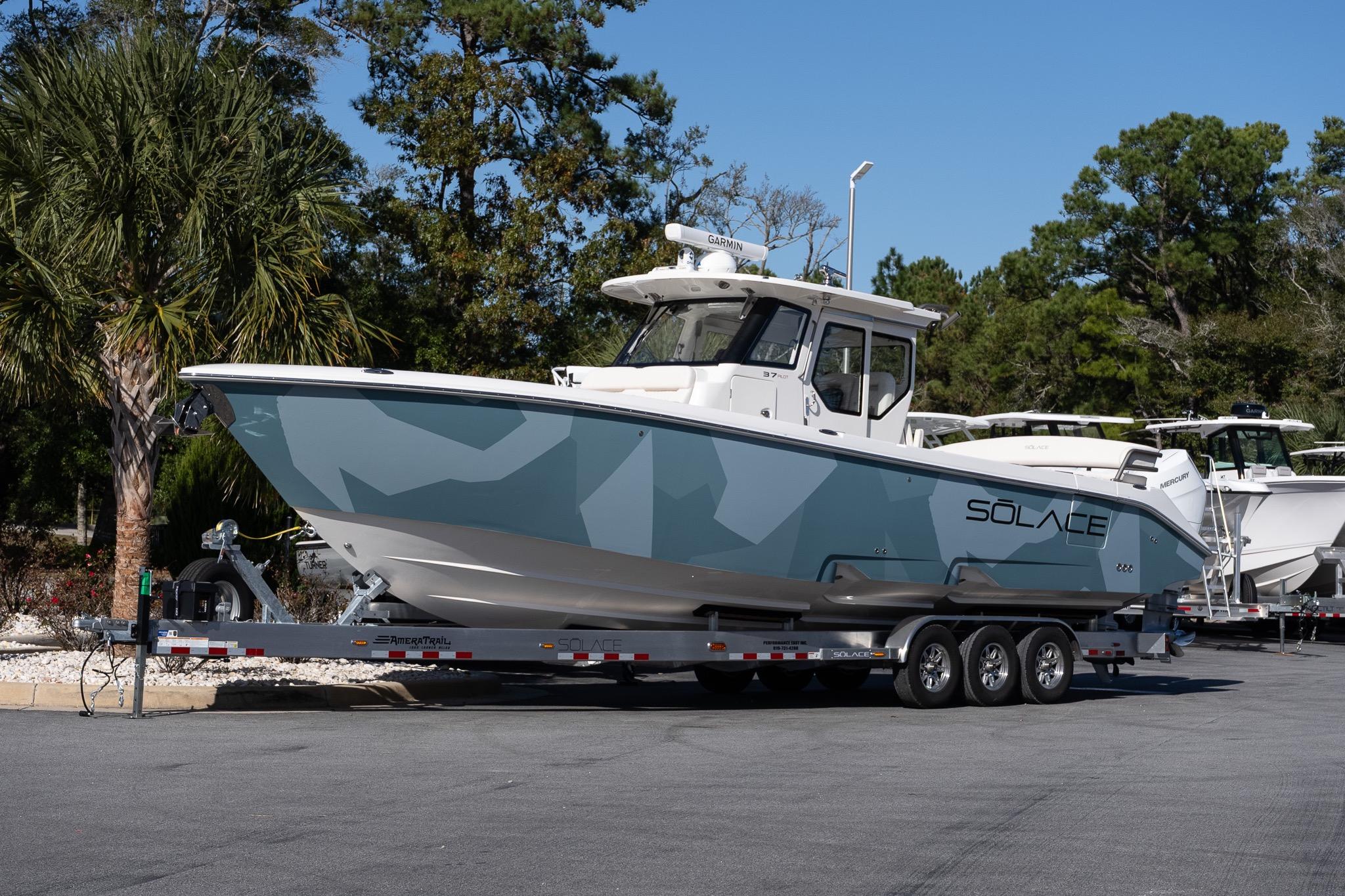 2026 Solace 37 Pilot boat on trailer, parked outdoors with trees in background.