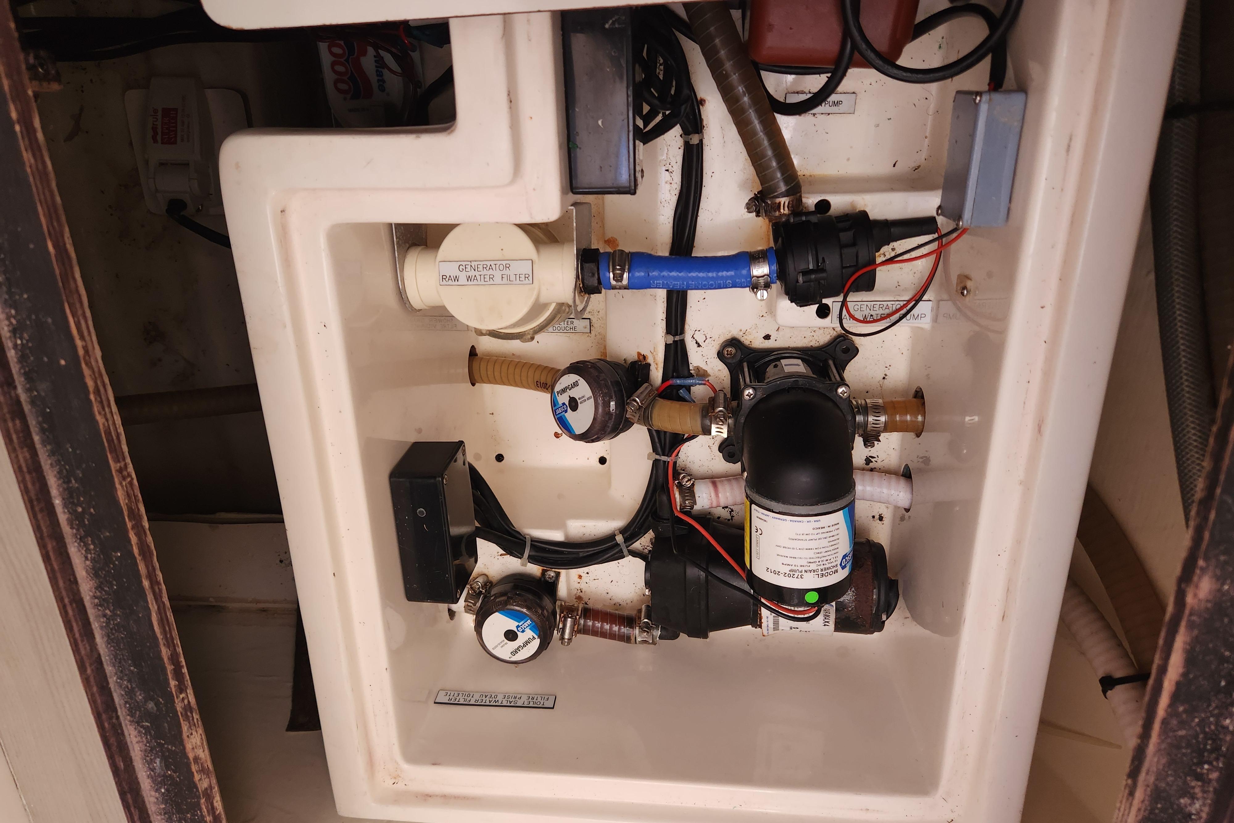 Engine compartment of a 2015 Leopard 44, showcasing water filtration and pump system.