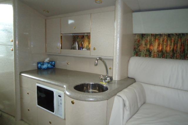 Interior of 1999 Formula 400 Super Sport yacht with kitchenette and seating area.
