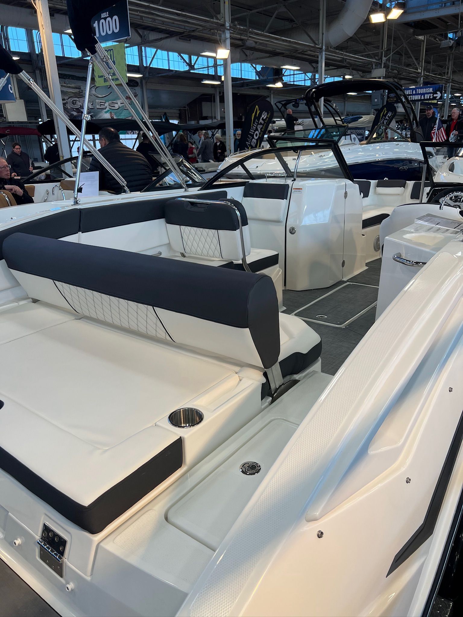 2022 Bayliner DX 2250 boat interior at a showroom, featuring sleek seating and modern design.
