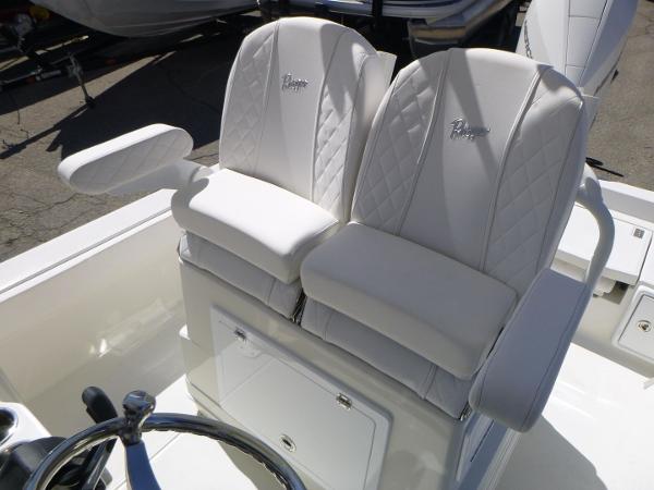 2024 Ranger 2360 Bay boat with white cushioned seats and steering wheel.