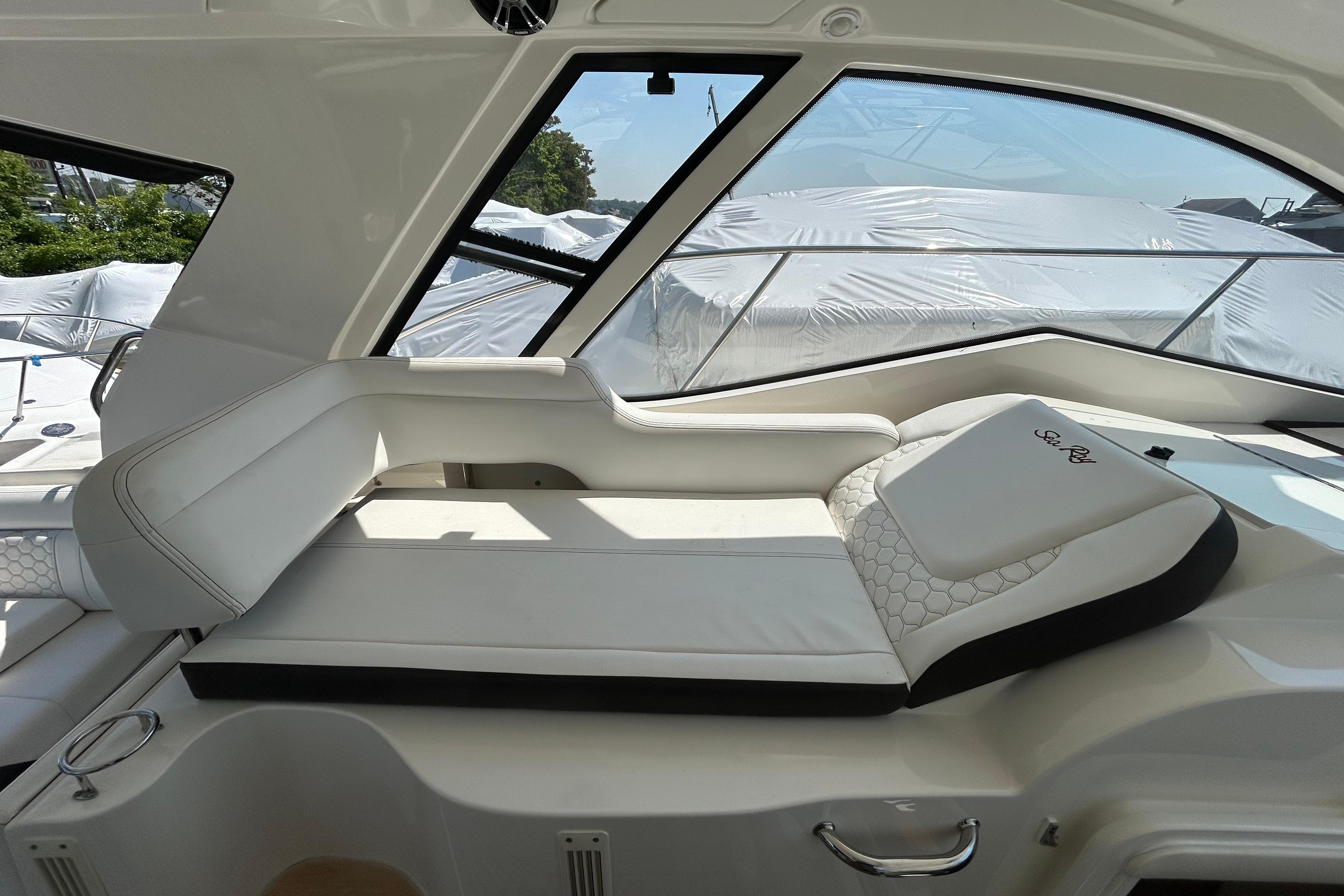Luxurious interior seating of 2019 Sea Ray Sundancer 350 yacht, featuring elegant white upholstery.