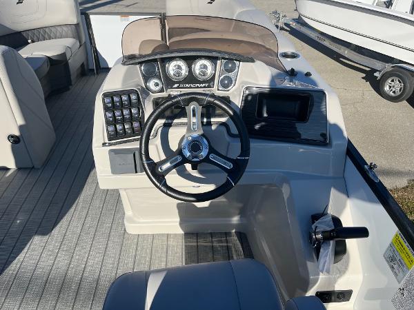 2024 Starcraft SLS3 boat dashboard with steering wheel and control panel.