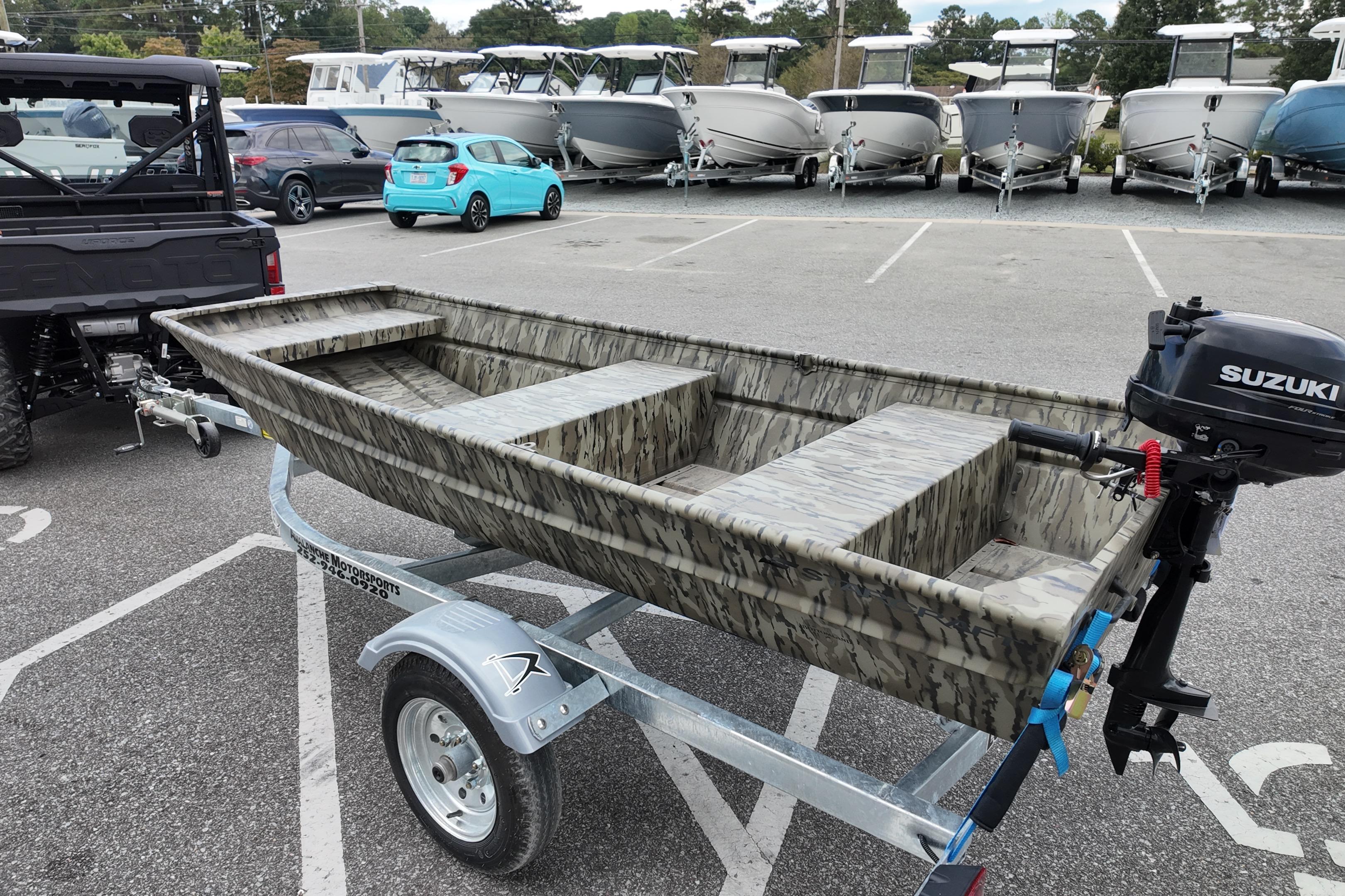2026 Starcraft JON 1032 boat on trailer with Suzuki outboard motor.