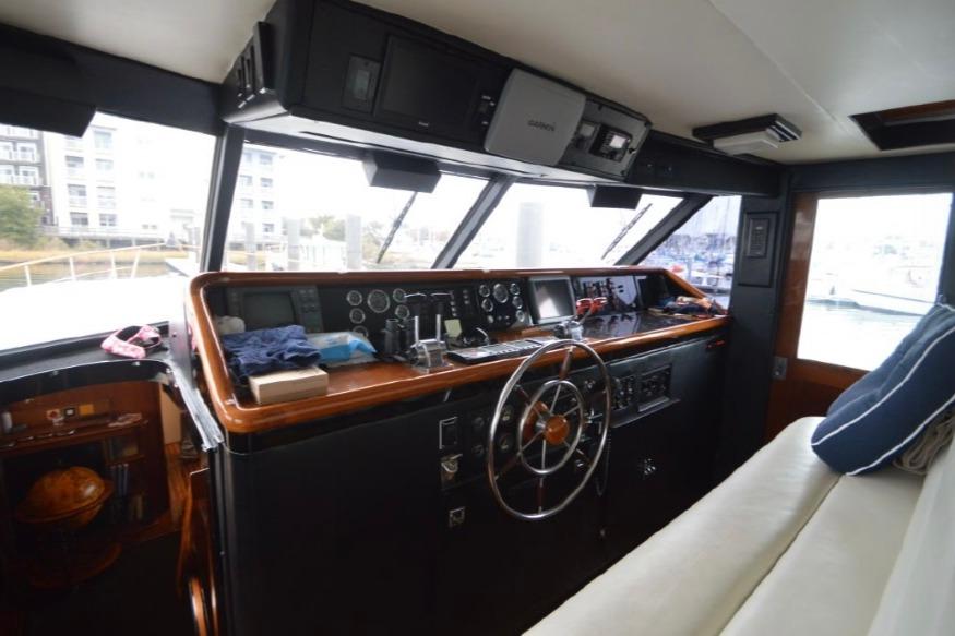 1974 Pacemaker Cockpit Motoryacht interior with steering wheel and control panel.